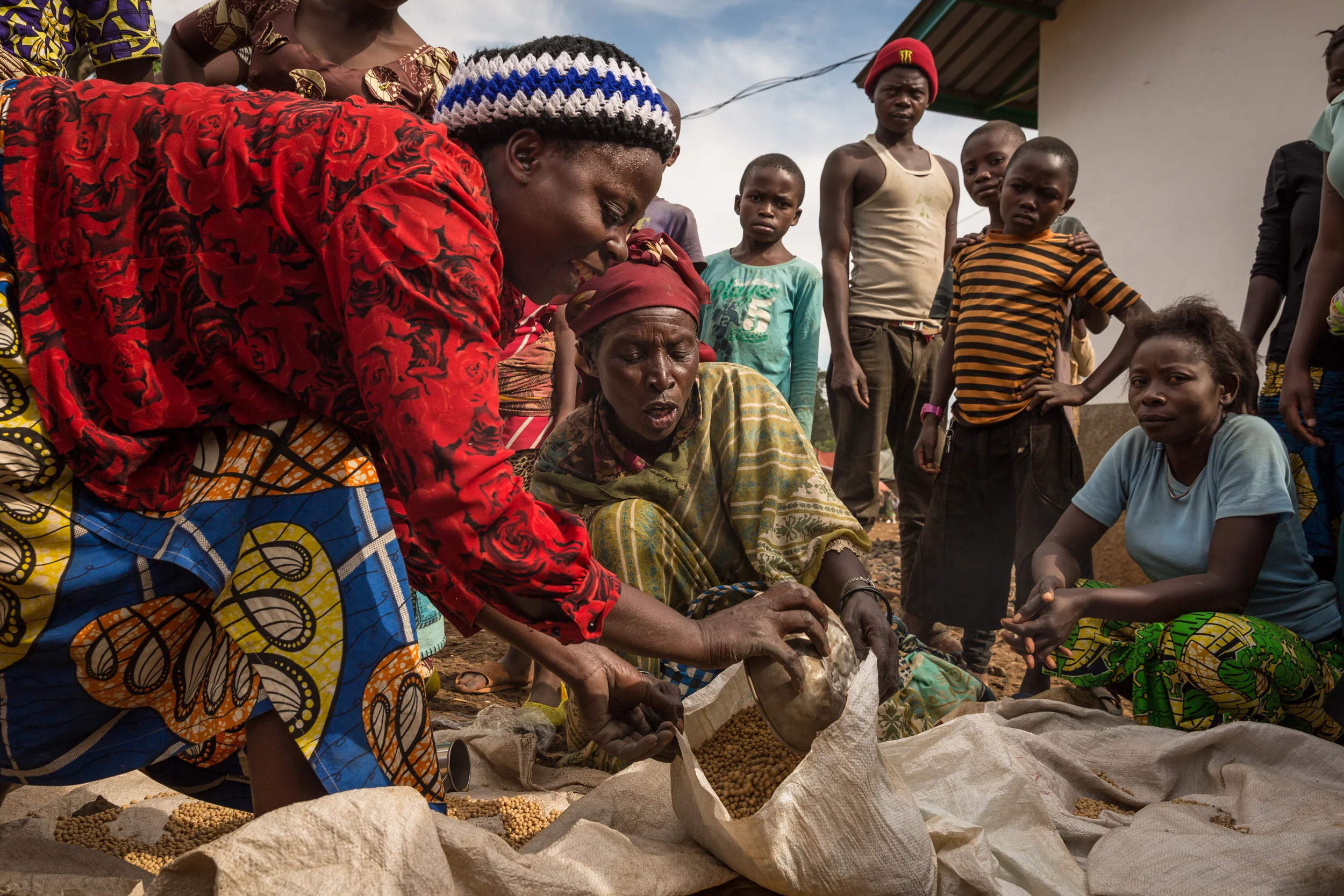 Congolese women load sacks full of dried soya beans in a market outside of Bukavu, Eastern Democratic Republic of Congo. 10.13.2017
