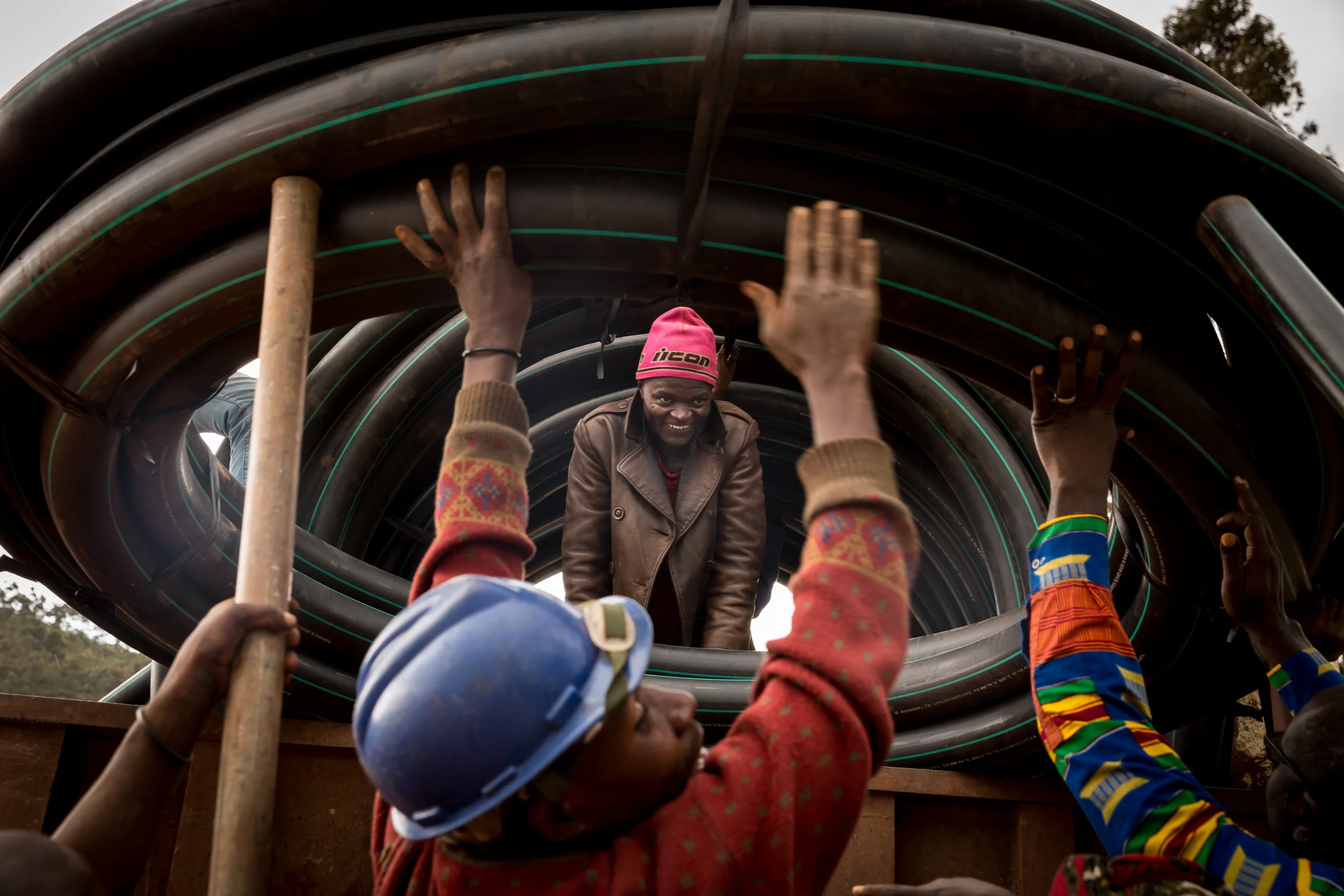 Men hoist water pipeline on to a truck in Eastern Democratic Republic of Congo. The pipeline is part of a 30km system that carries fresh, filtered mountain water to Bukavu and outlying, rural areas. 10.22.2017