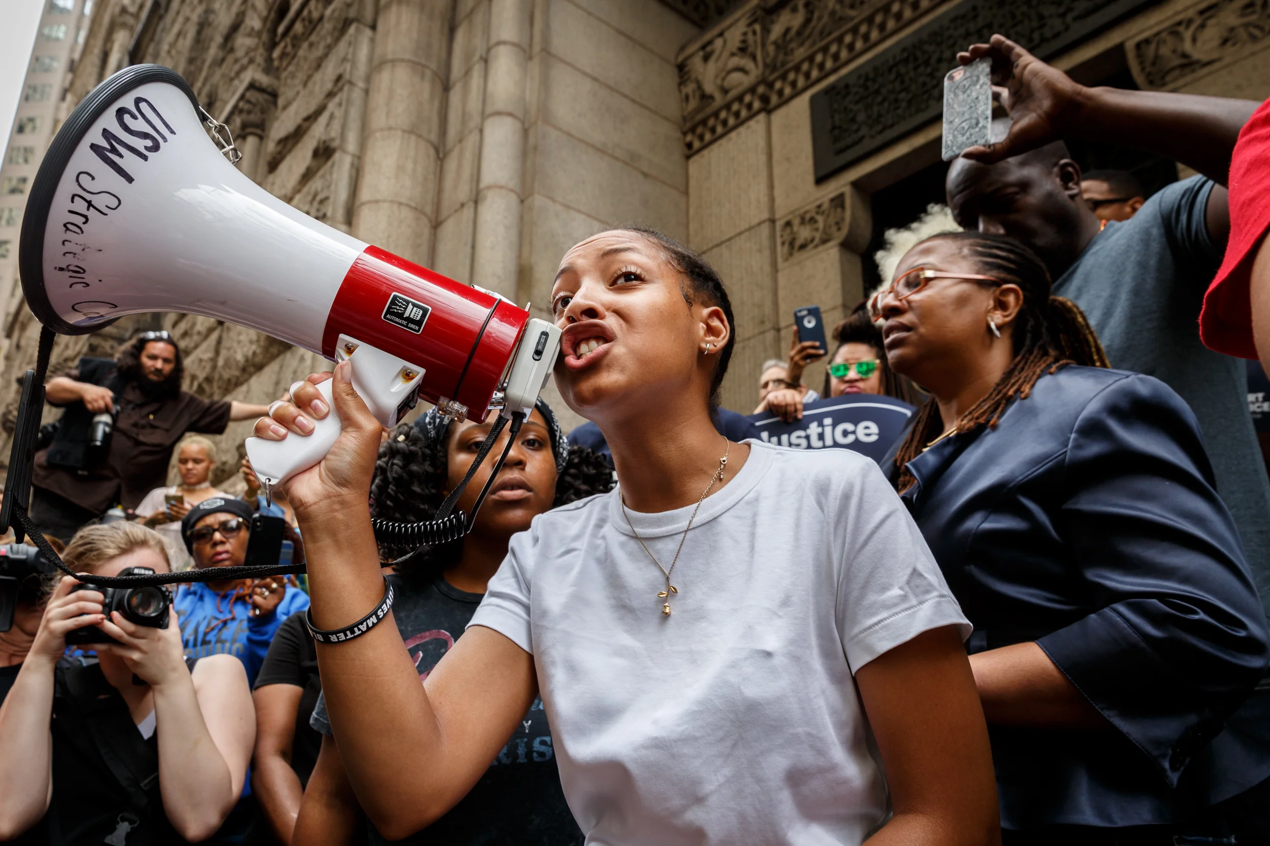Anyah Jackson, 18, of Pittsburgh, a member of the Youth Power Collective, rallies the crowd using a bullhorn.