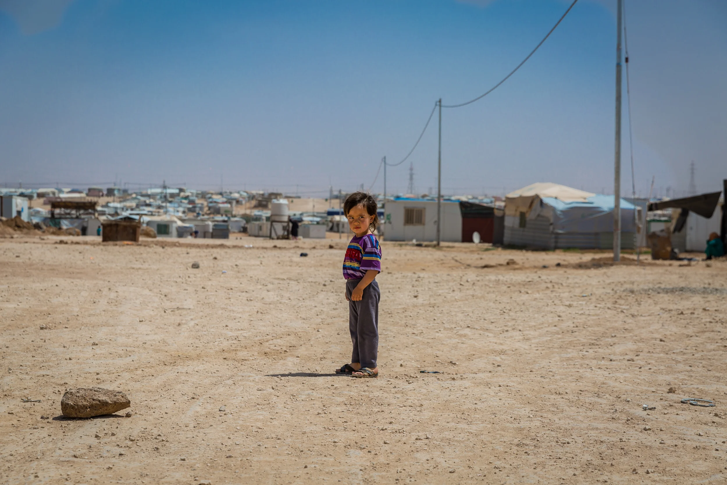 04.08.2016 Inside the Zaatari Refugee Camp Since the eruption of the brutal conflict in Syria in March of 2011, millions of Syrians have fled their homes in search of peace, safety, and some sense of normalcy. While tens of thousands have and continue to seek refuge in neighboring countries, the Zaatari refugee camp has quickly become a semi-permanent home for nearly 100,000 individuals, the majority of who once lived in the Da’ara Governorate in Syria’s southwest. Located 10 km east of the city of Mafraq and first opened on July 28, 2012, the camp is a three-square-mile piece of land in the desolate Jordanian desert; it was initially designed to host a maximum of 60,000 inhabitants and is jointly administered by the Jordanian government and the UNHCR (United Nations High Commission for Refugees). The camp, which has fluctuated in population to as high as 250,000, is now the 4th largest ‘city’ in the Hashemite kingdom of Jordan.