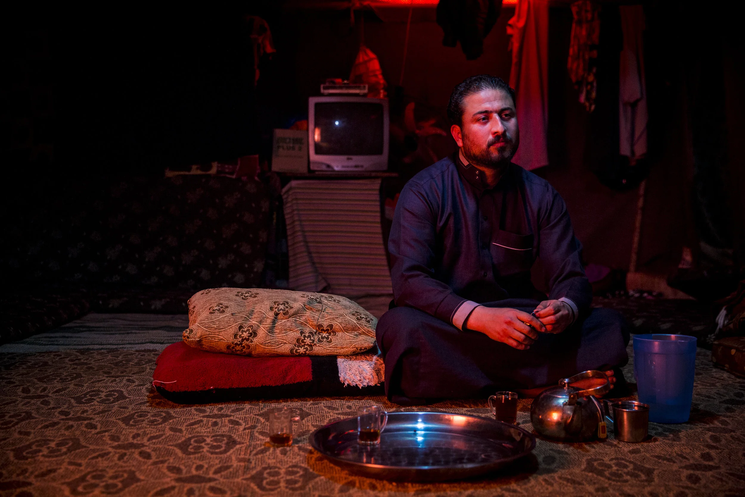 Halid, father of four, sits in a neighbors home within the Mafraq tent camps 4.21.2016