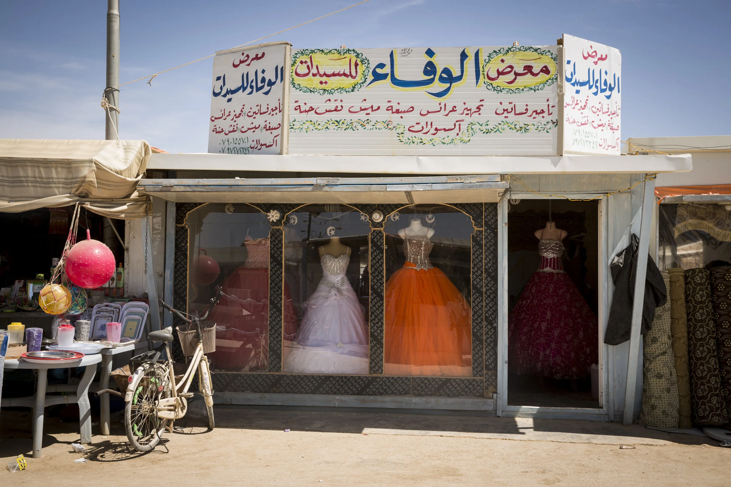 A wedding gown shop displays rental dresses for those who are married while living in the camp. Inside the Zaatari Refugee Camp 04.17.2016