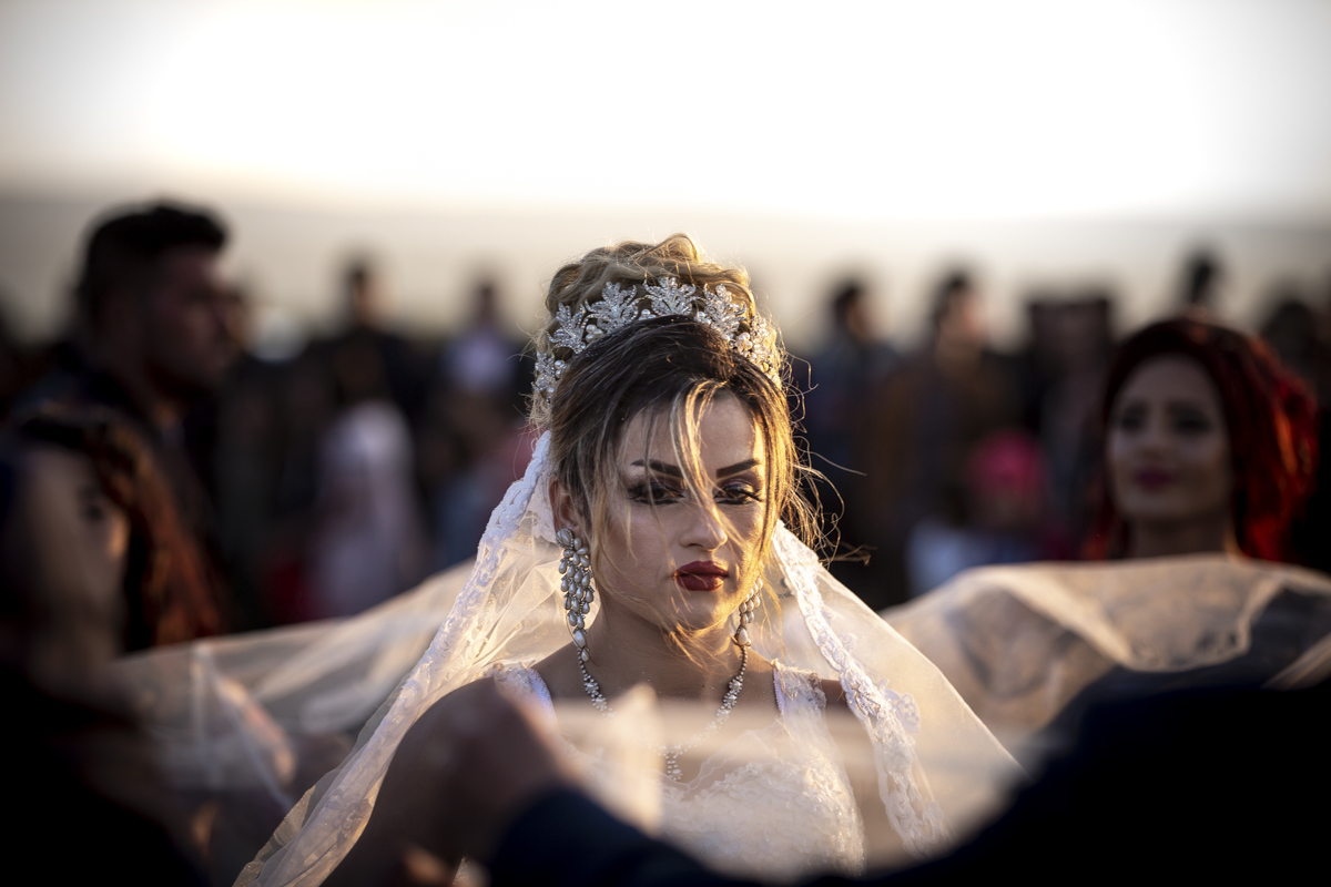 A Yazidi Wedding: The marriage of Amera and Samir took place just outside the Bajed Kandala camp. Several hundred from the community attended the traditional celebration, dancing throughout the day and evening. When night fell everyone returned to the camp and tents they've called home since 2014.
