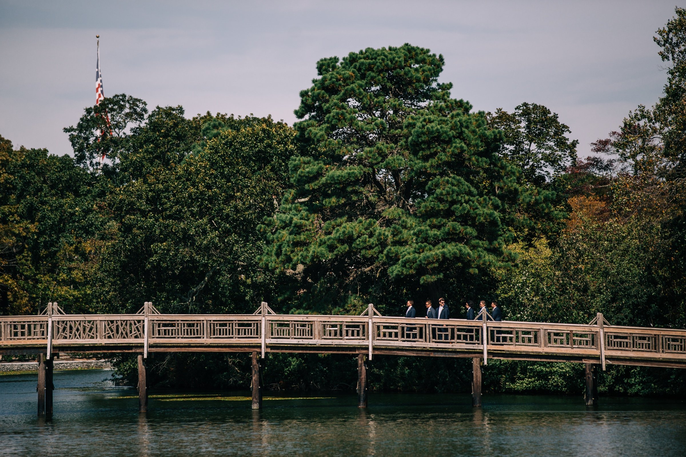 34_groomsmen walking to ceremony bay head new jersey wedding.jpg