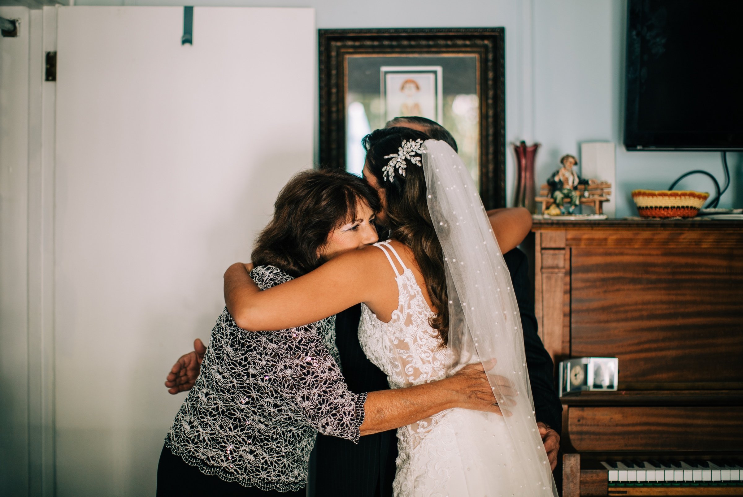 13_bride with parents before historic chapel allaire village wedding new jersey.jpg
