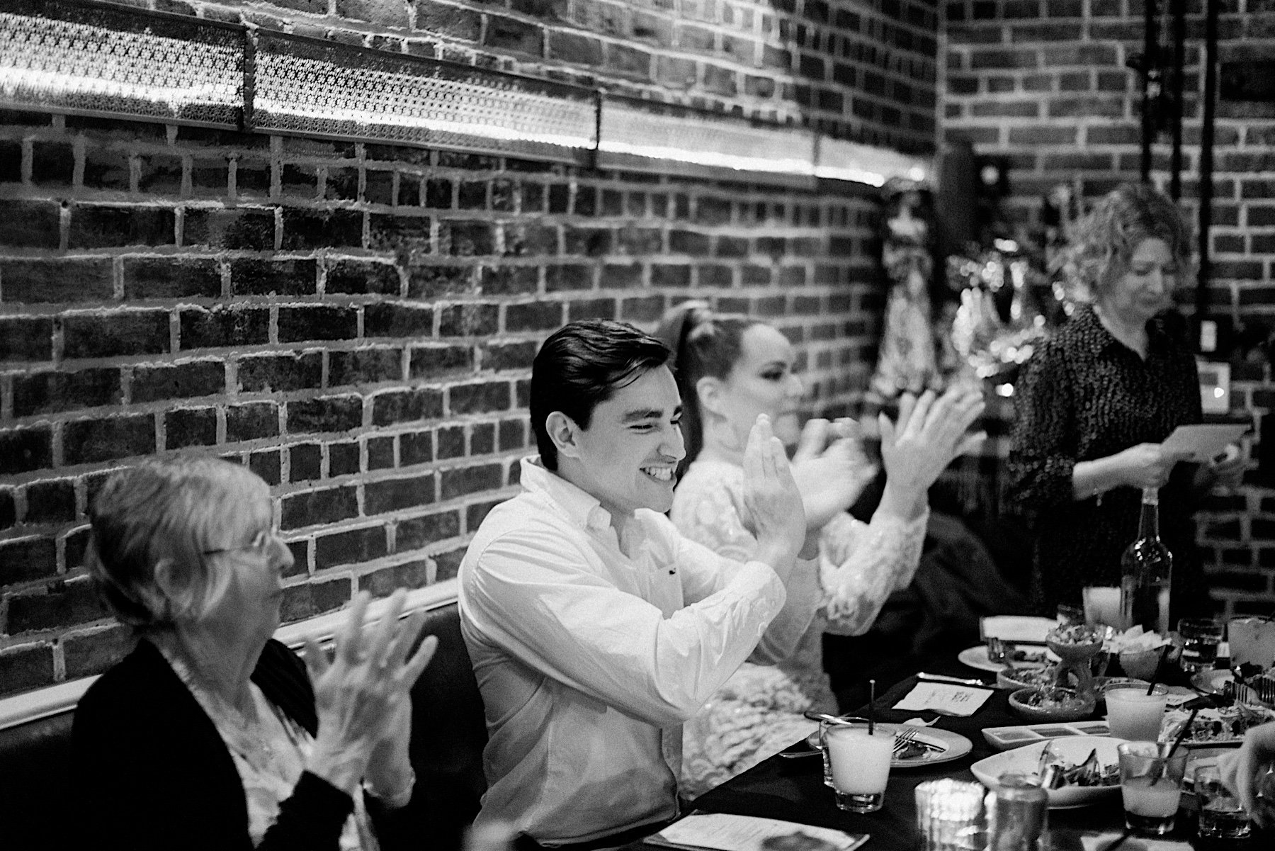 12_guests clapping at jersey city rehearsal dinner oral restaurant.jpg