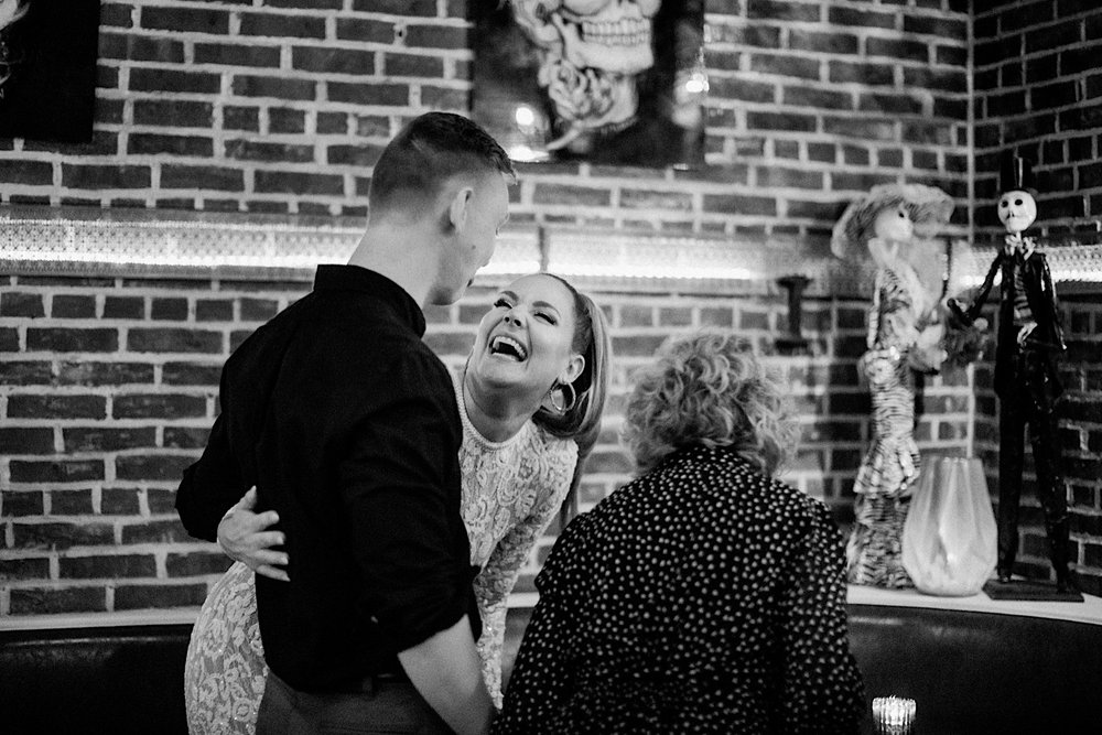 16_urban bride and groom laughing photos jersey city rehearsal dinner.jpg