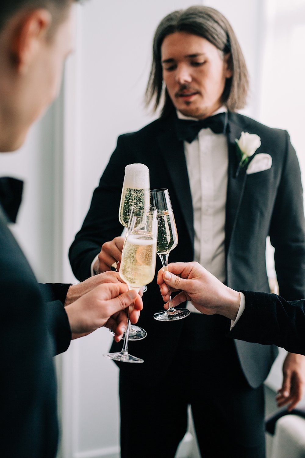34_groom with groomsmen champagne toast before jersey city wedding.jpg