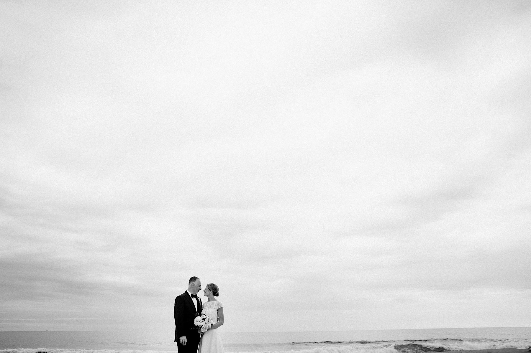 49_cloudy beach couples portraits spring lake nj.jpg