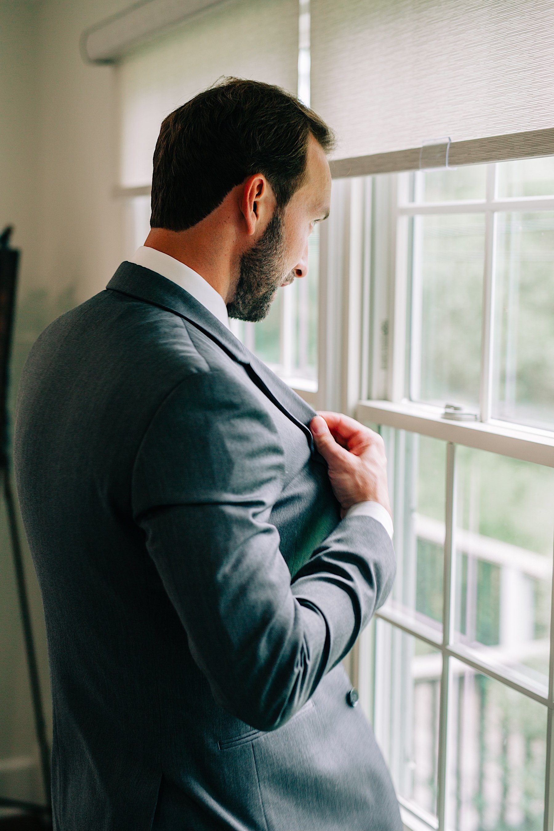 31_groom getting jacket on cross keys estate wedding.jpg