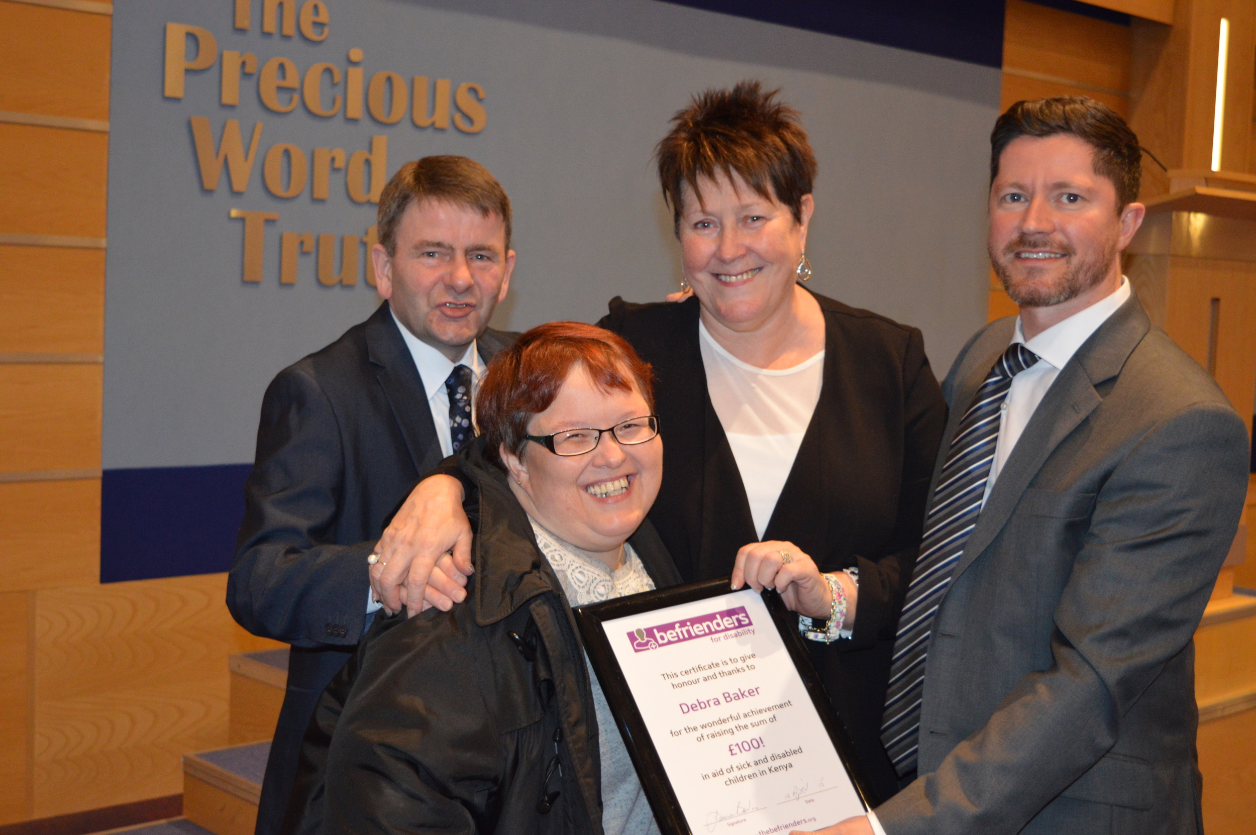 Debra Baker being presented with her certificate, along with Pastor Irwin Rea (left) Mrs Terry Fairfowl, and Pastor David Murray.