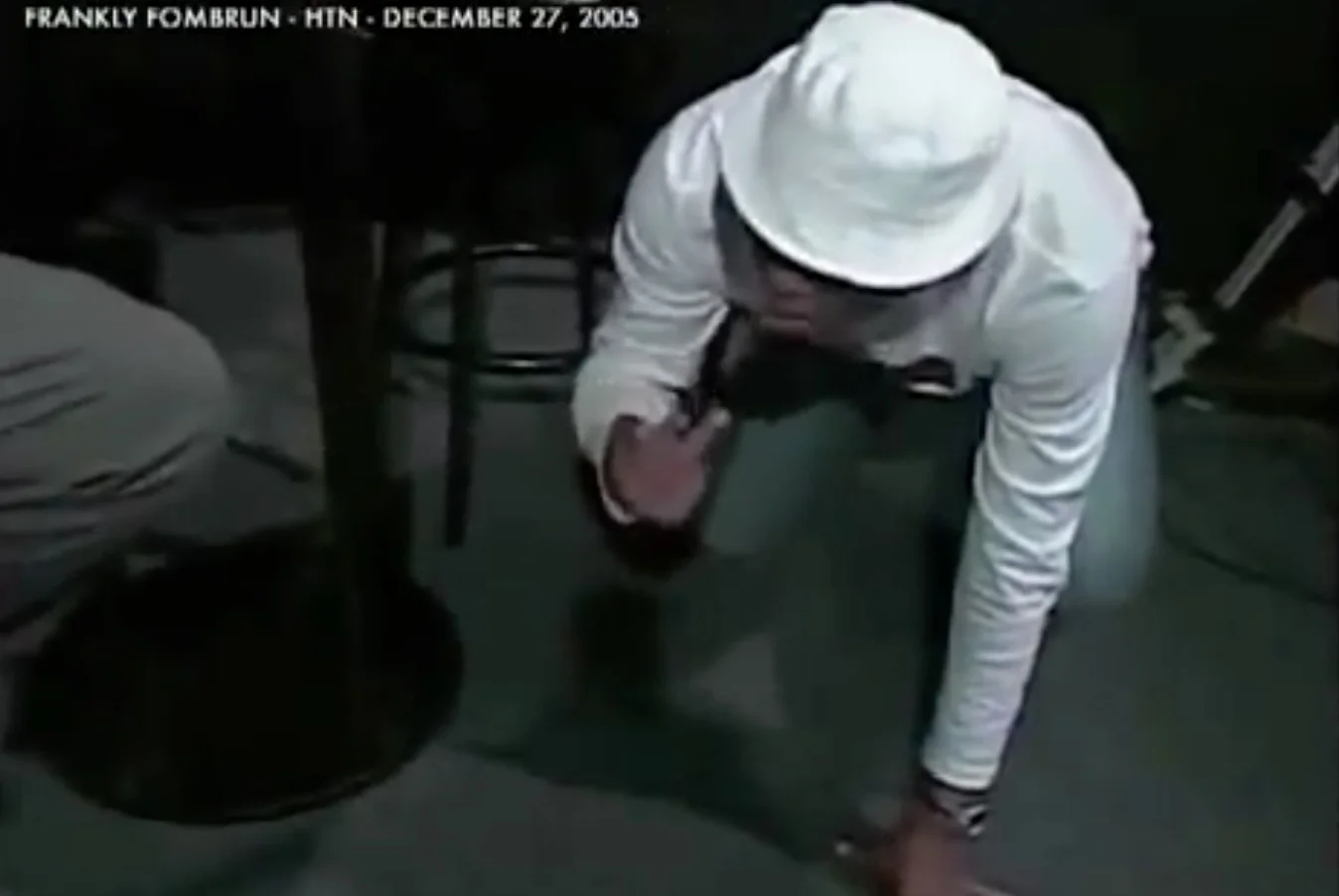 Martelly crawling on the ground acting out a time in his life when he worked in a cement factory. He was using a lot of drugs at the time, and dropped a back of drugs on the ground and couldn't tell the difference between the drugs and the cement and was crawling around trying to taste the cement to identify where he dropped the drugs. 