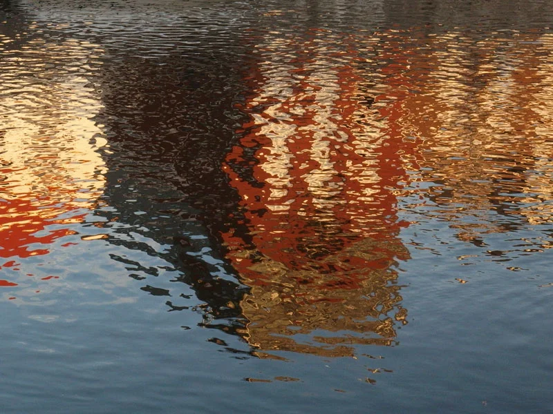 lovely the reflections of the houses in the water of the river in the warm light of the sun which was already going down