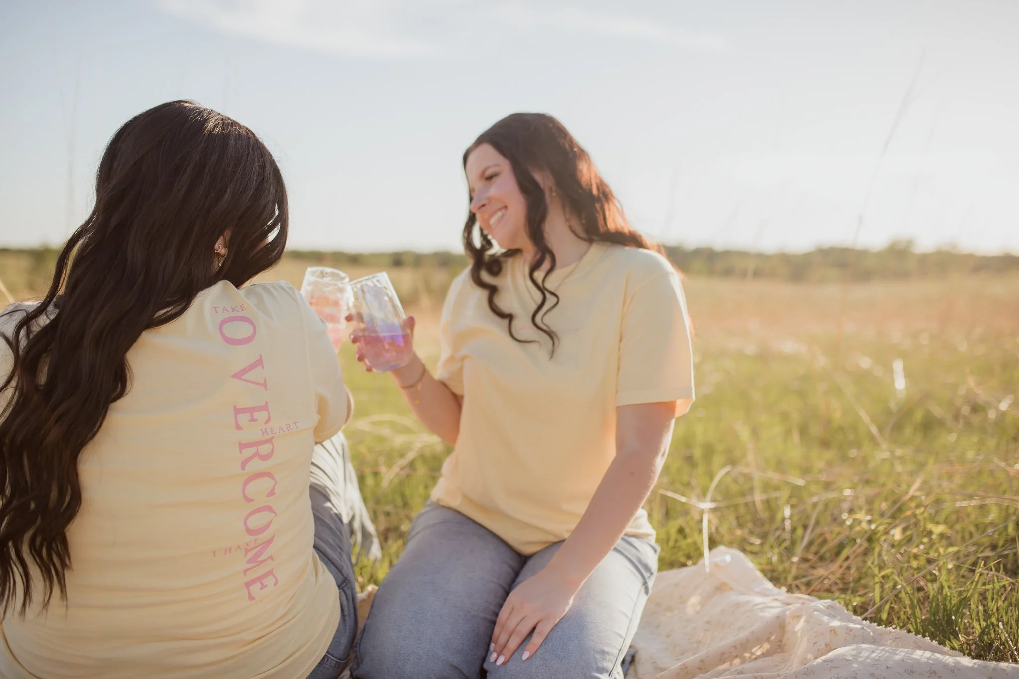 Christian comfort colors Take Heart I have Overcome T-shirt inspired by John 16:33.  Butter yellow tee with pink screen print reminding believers Christ as overcome.