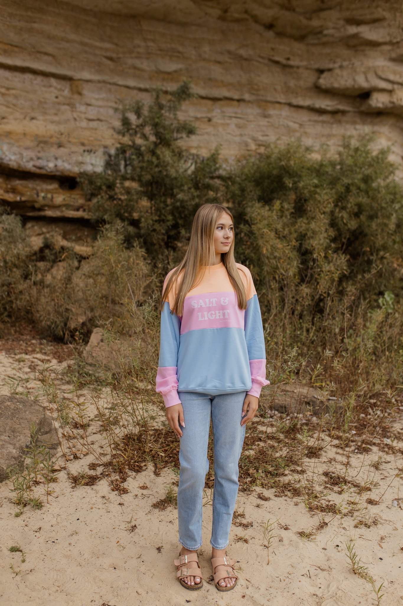 Wearing a pastel color-block sweatshirt with the words "Salt & Light" on the front for Fall Line christian clothing brand photoshoot.