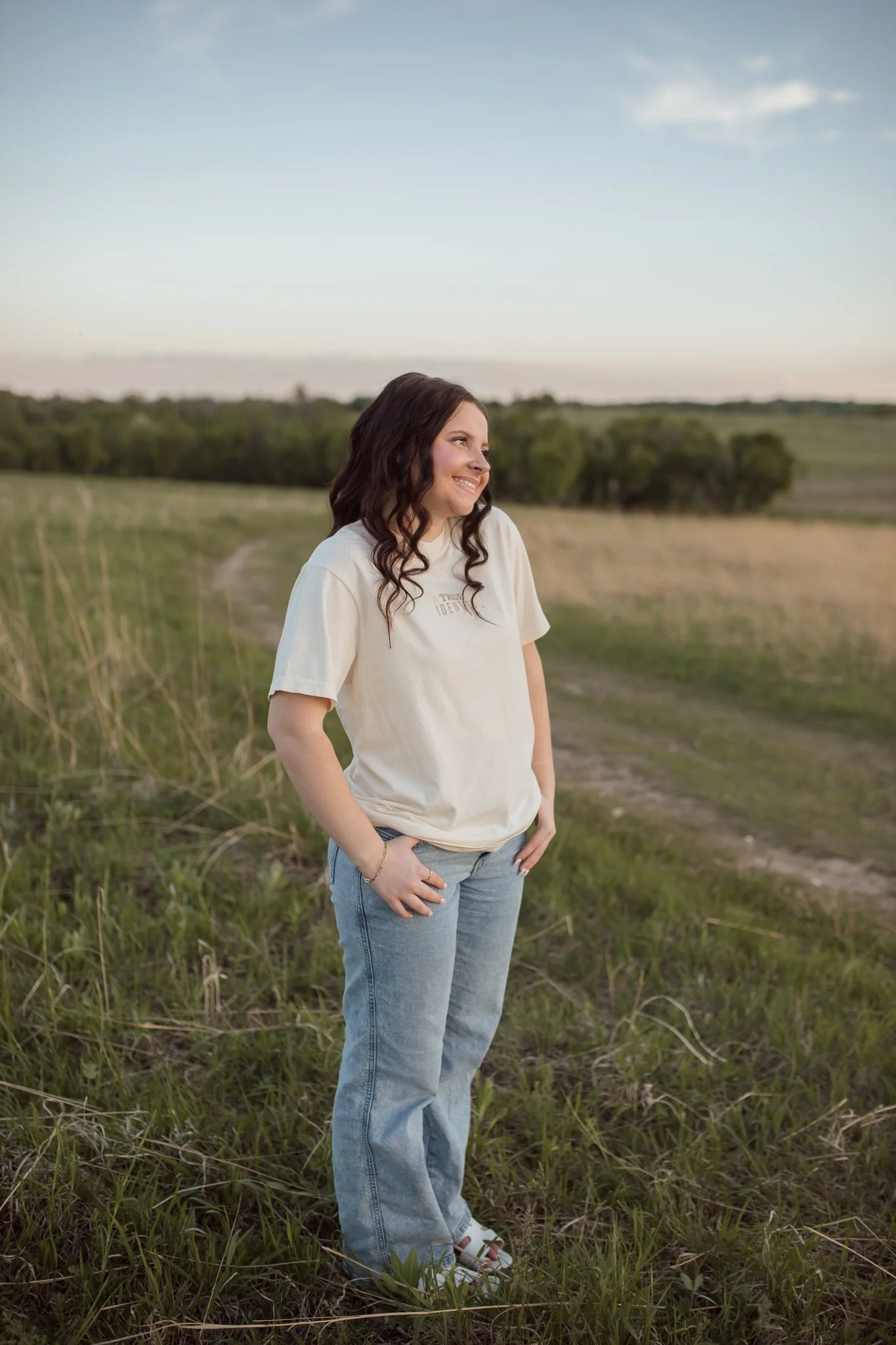 Christian comfort colors True Identity in Christ T-shirt inspired by bible verse Ephesians 1:3-8.  ivory tee with pink and tan screen print reminding believers that they are deeply chosen and loved.