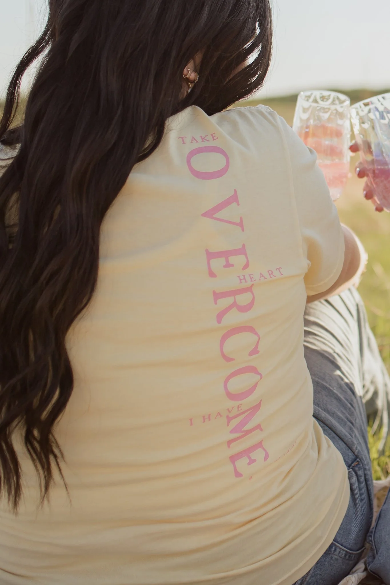 Christian comfort colors Take Heart I have Overcome T-shirt inspired by John 16:33.  Butter yellow tee with pink screen print reminding believers Christ as overcome.