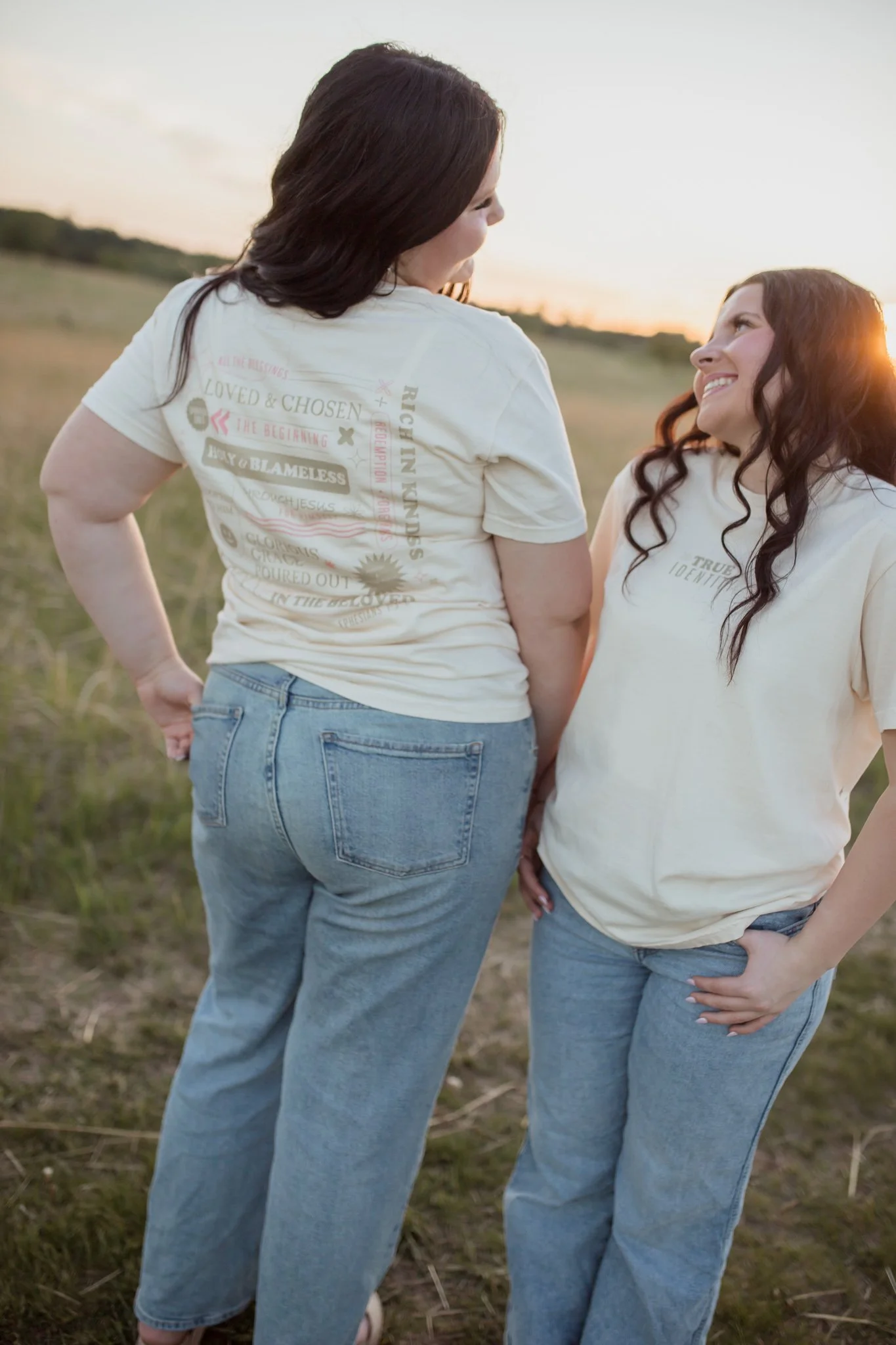Christian comfort colors True Identity in Christ T-shirt inspired by bible verse Ephesians 1:3-8.  ivory tee with pink and tan screen print reminding believers that they are deeply chosen and loved.