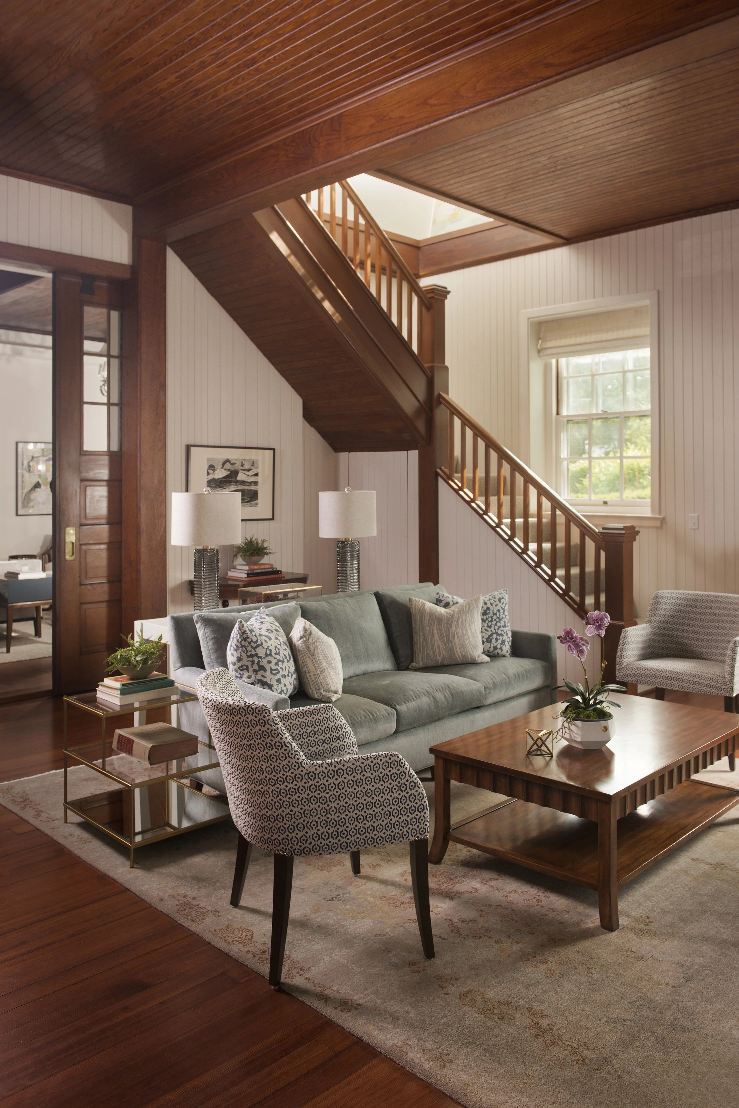 Modern textiles, a mixture of new accent furniture and lighting, and bright windows were exactly what this room called for. Not to mention that gorgeous rug! Bigger isn't always better, scale is just as important as style.