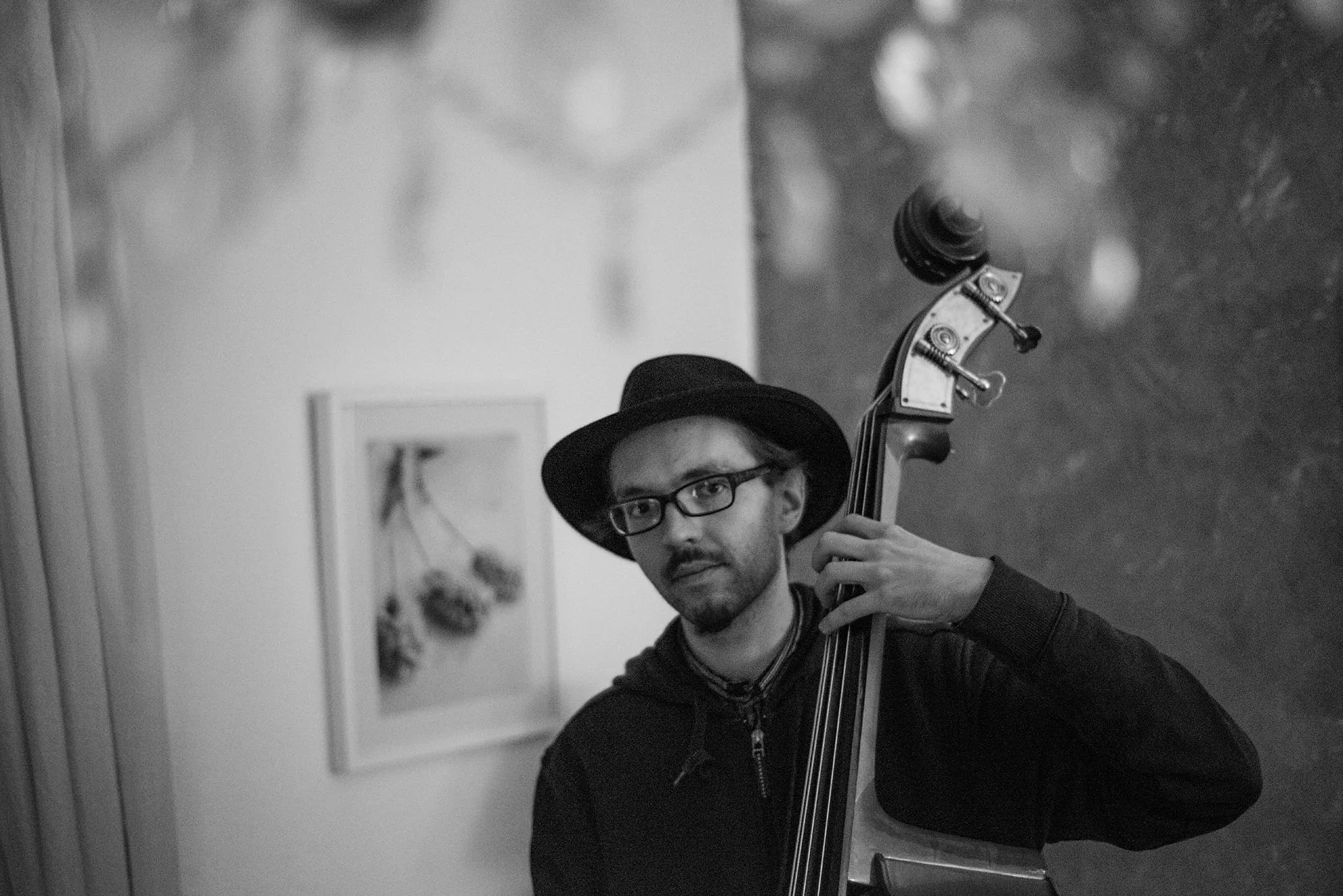  Man in a hat and glasses playing the double bass, Berlin. Candid street portrait by Chris Perona. 