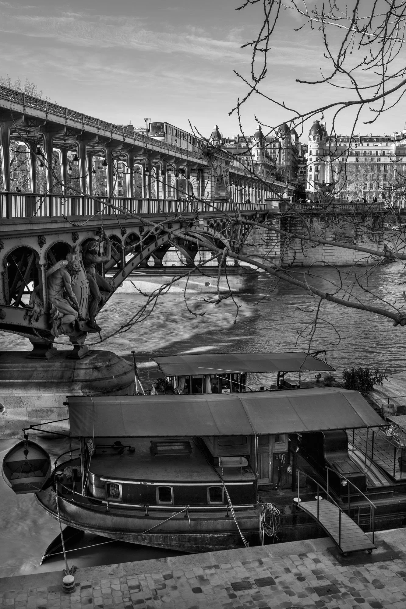  Arches of the Pont de Bir-Hakeim above a moored houseboat on the Seine, Paris. Photograph by Chris Perona. 