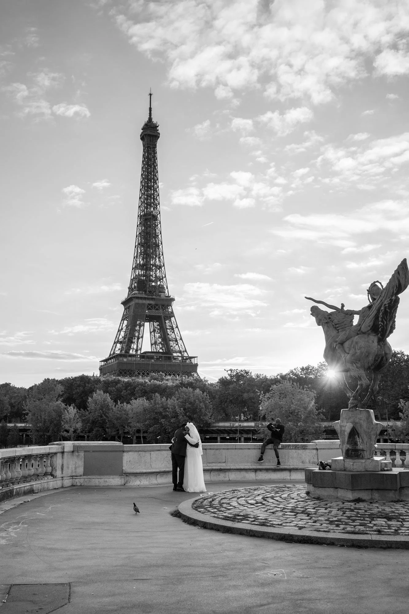  Bride alone on the bridge at sunrise, with the statue and the Eiffel Tower, Pont de Bir-Hakeim, Paris. Street photograph by Chris Perona. 