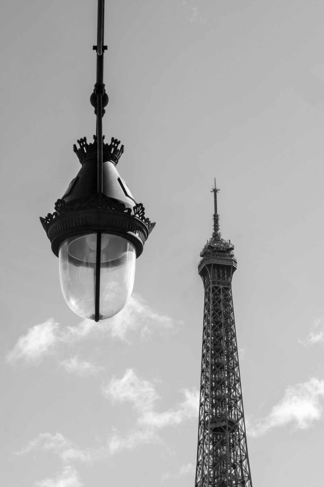  An ornate street lamp hanging beside the top of the Eiffel Tower, Pont de Bir-Hakeim, Paris. Photograph by Chris Perona. 