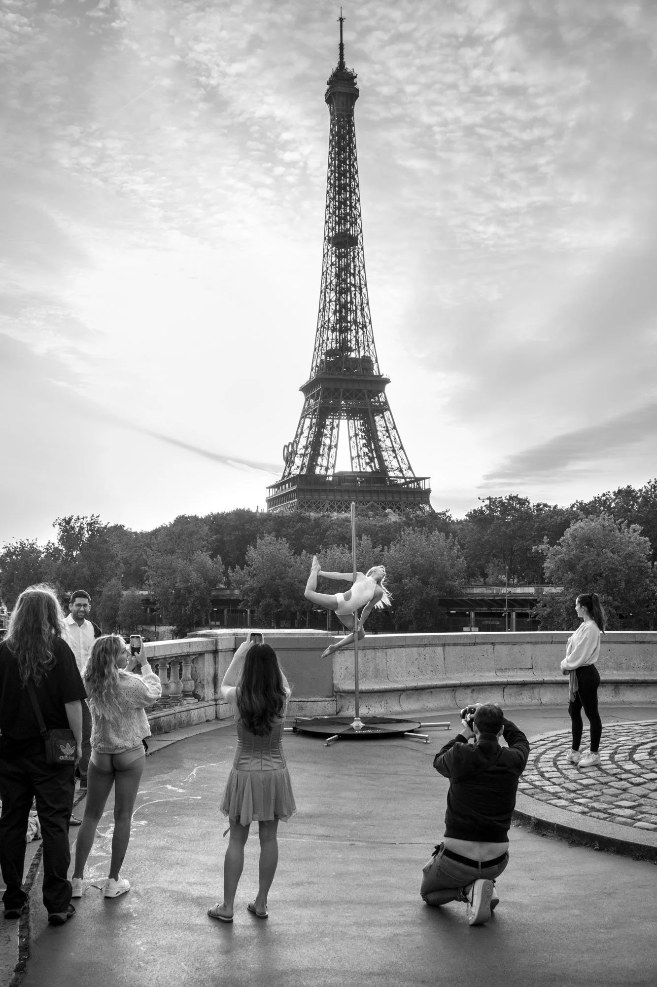  Photographers capturing a woman posing on the parapet before the Eiffel Tower, Pont de Bir-Hakeim, Paris. Street photograph by Chris Perona. 