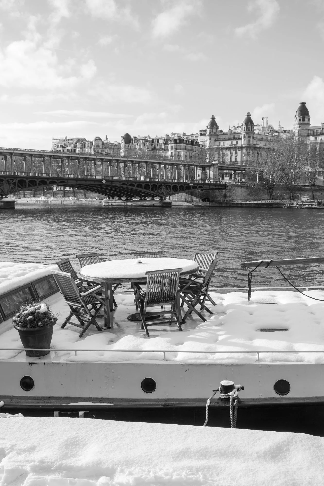  Snow-covered deck of a houseboat on the Seine, the bridge behind, Pont de Bir-Hakeim, Paris. Photograph by Chris Perona. 