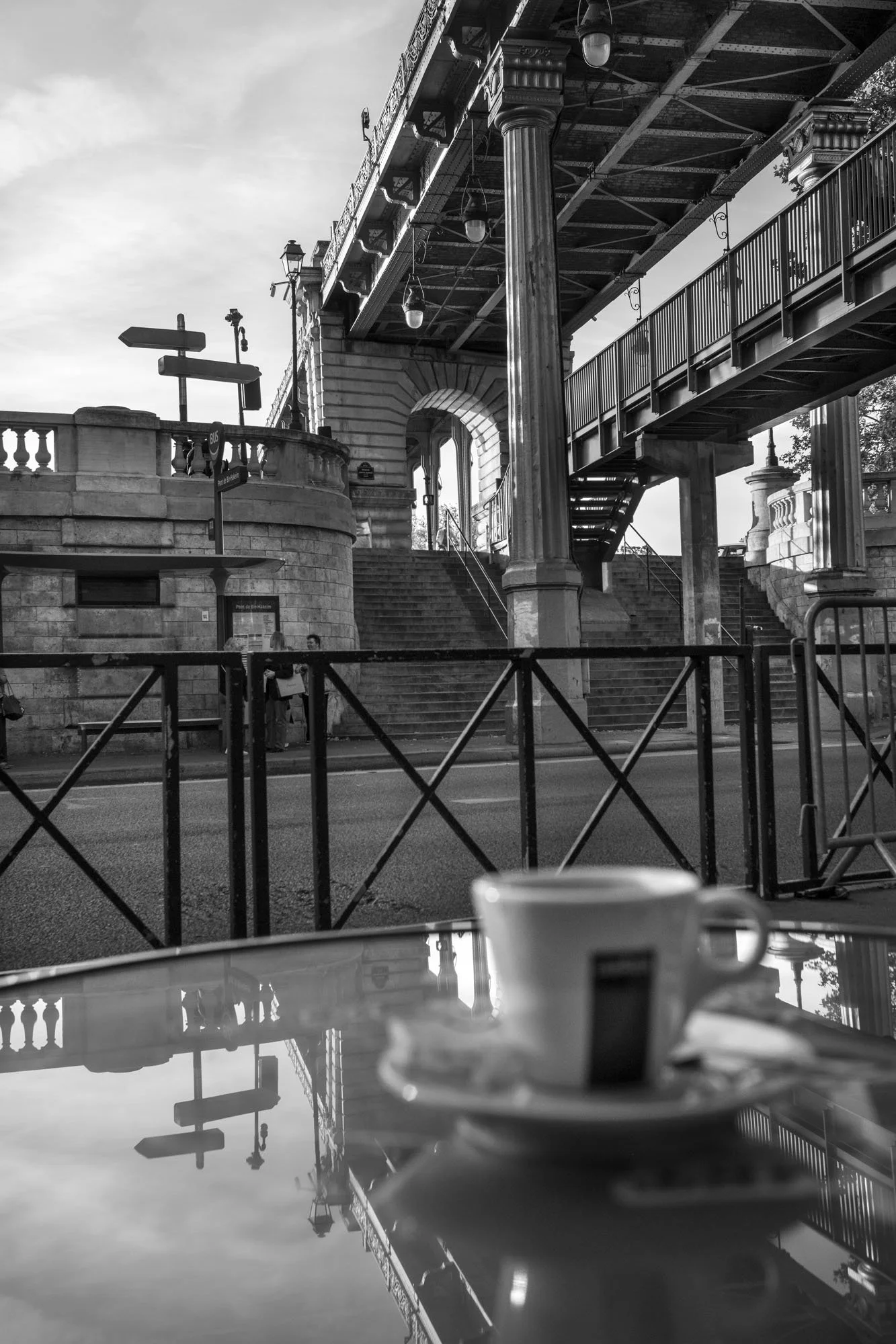  Espresso cup on a café table reflecting the iron structure of the Pont de Bir-Hakeim, Paris. Photograph by Chris Perona. 