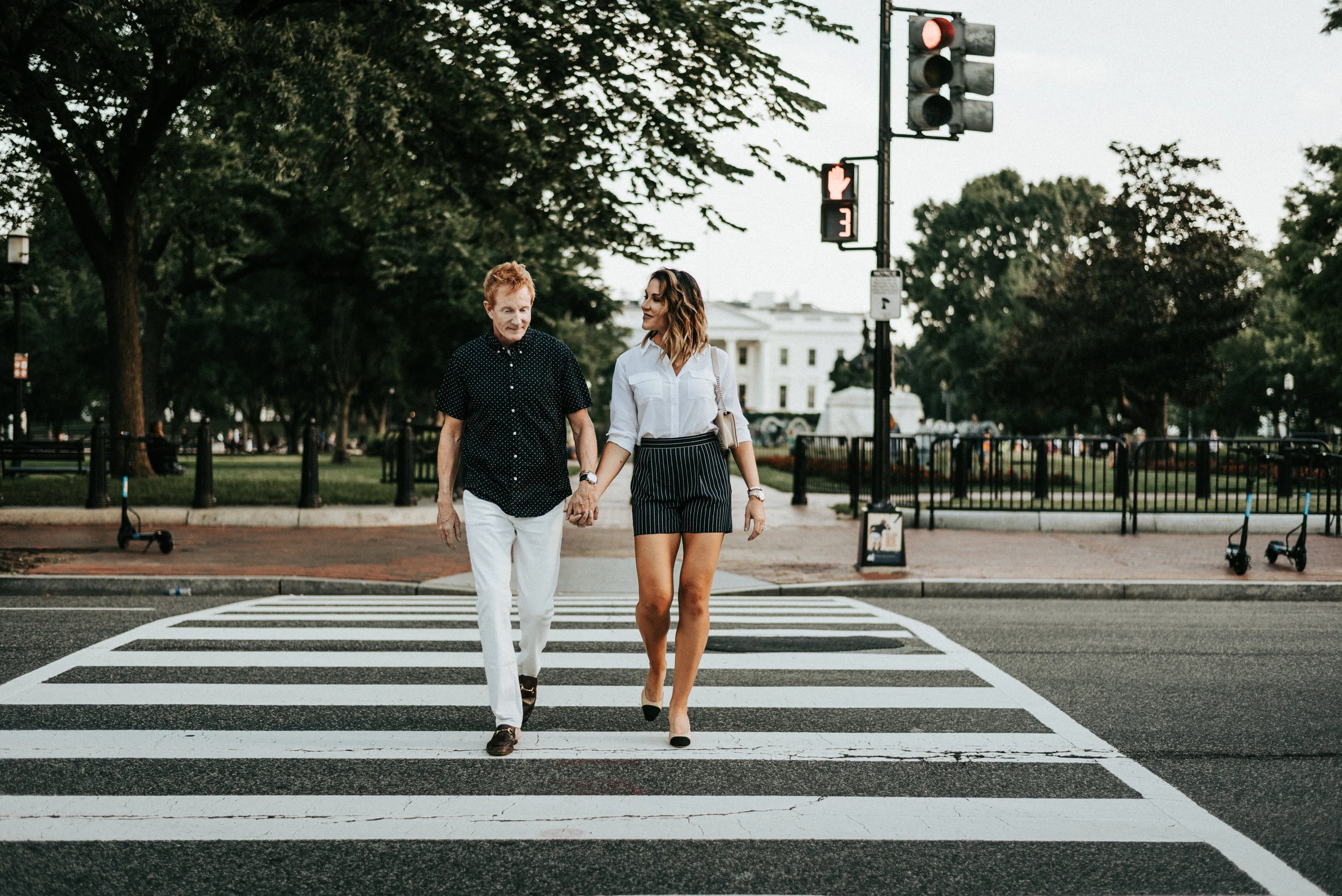 couple holding hands on crosswalk in front of the White House in Washington D.C.