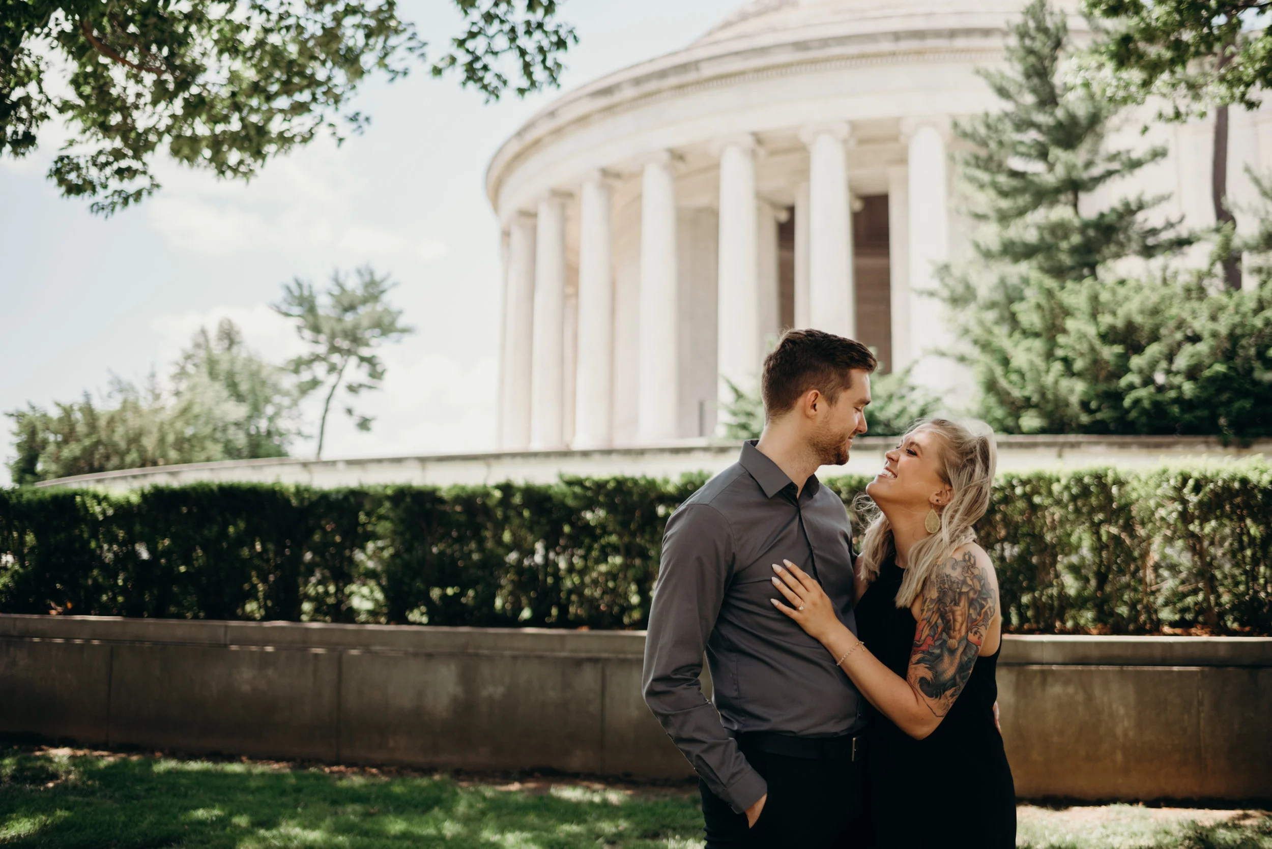 engaged couple posing in front of Thomas Jefferson Memorial