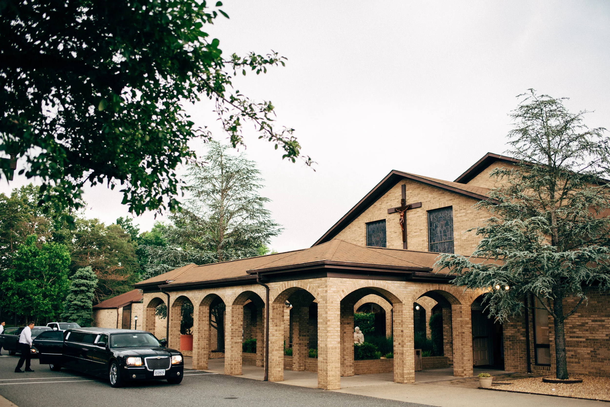Limo in front of St. Francis of Assisi Catholic Church before wedding ceremony