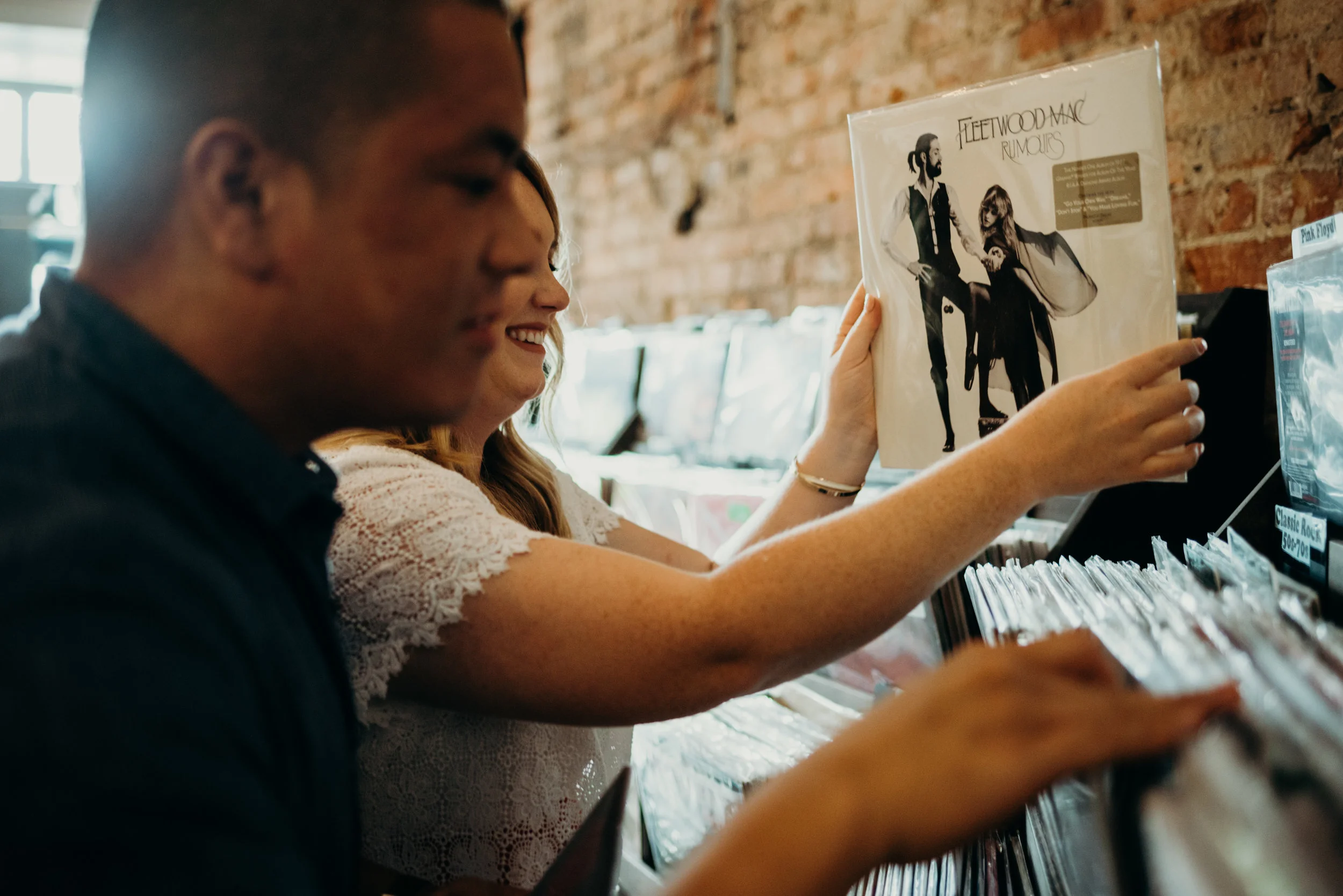 shopping for Fleetwood Mac record during engagement photography session