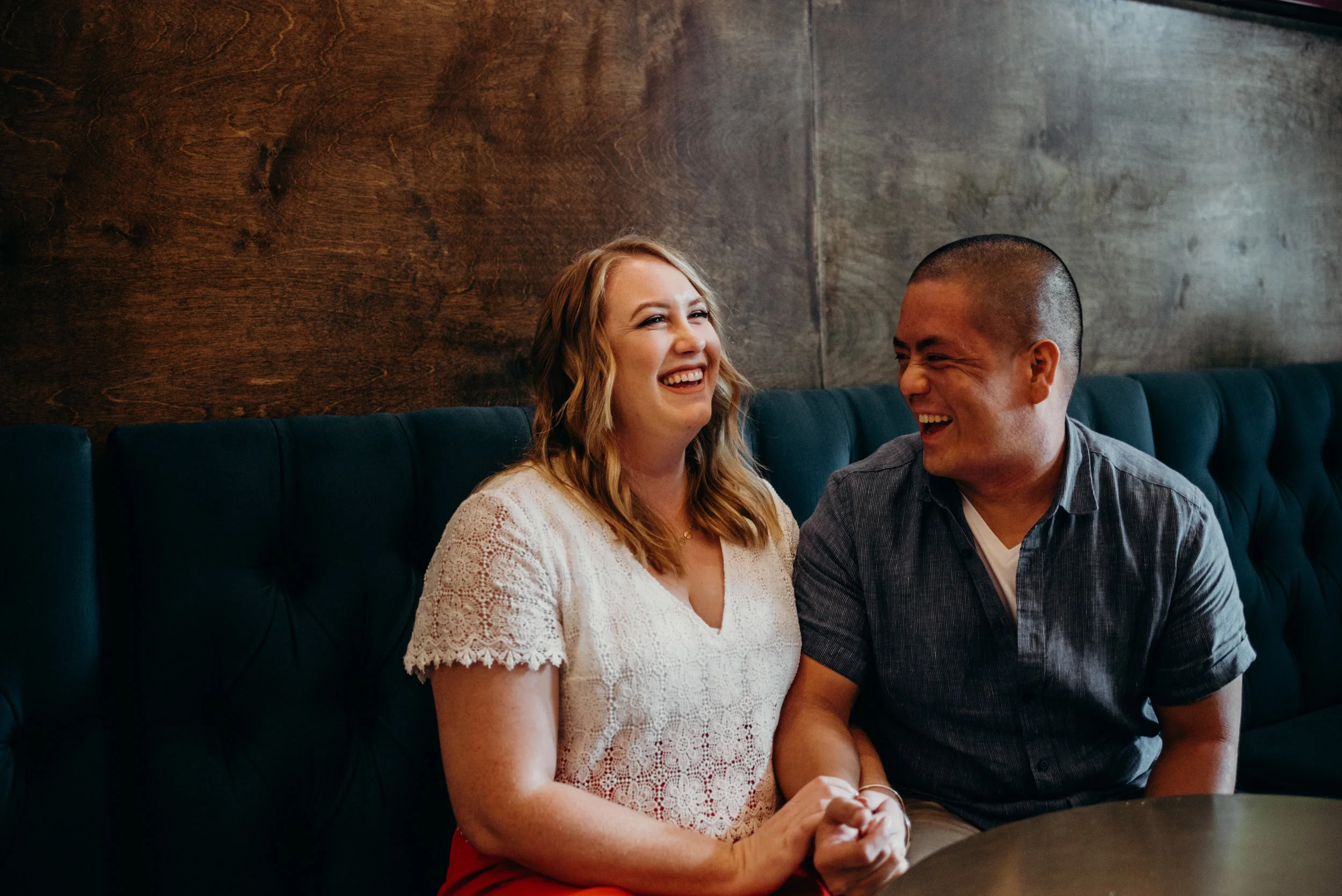 engaged couple laughing together in record store cafe in Washington DC