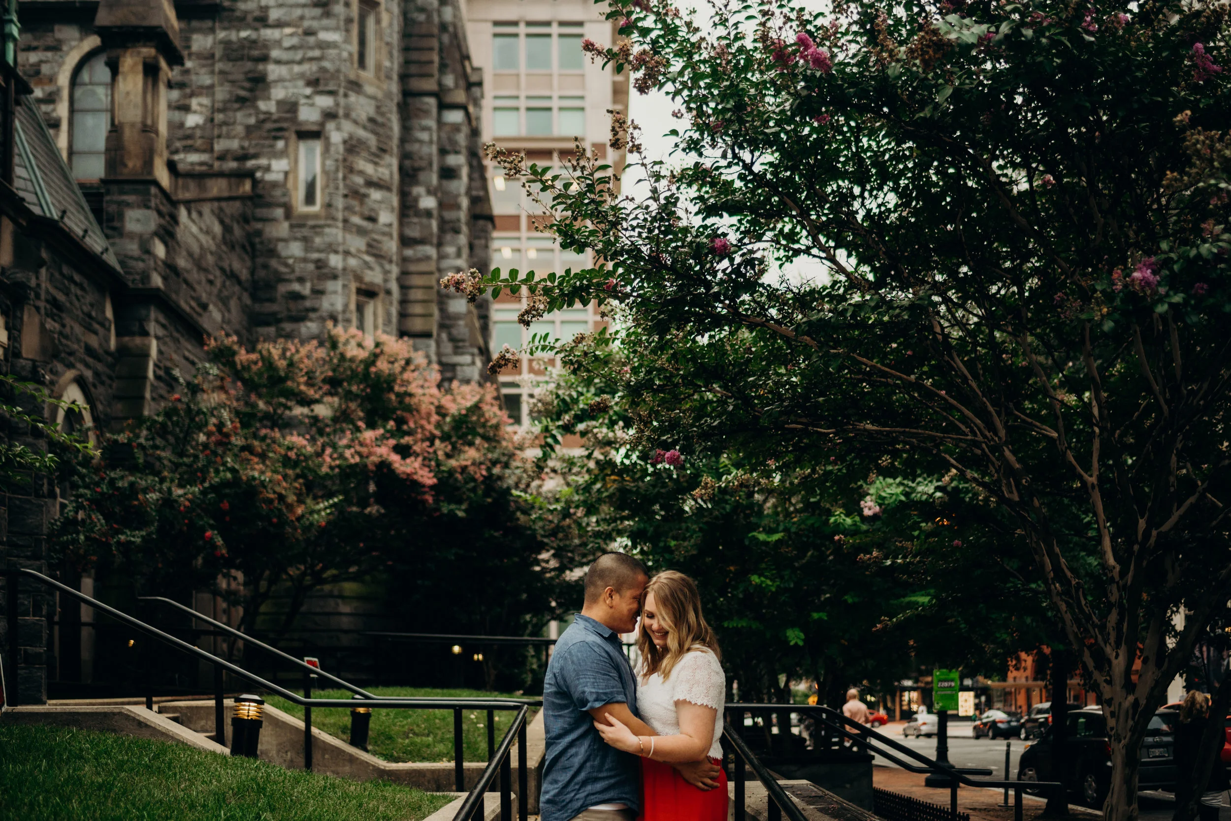 engaged couple embracing with trees in the background in Washington, DC