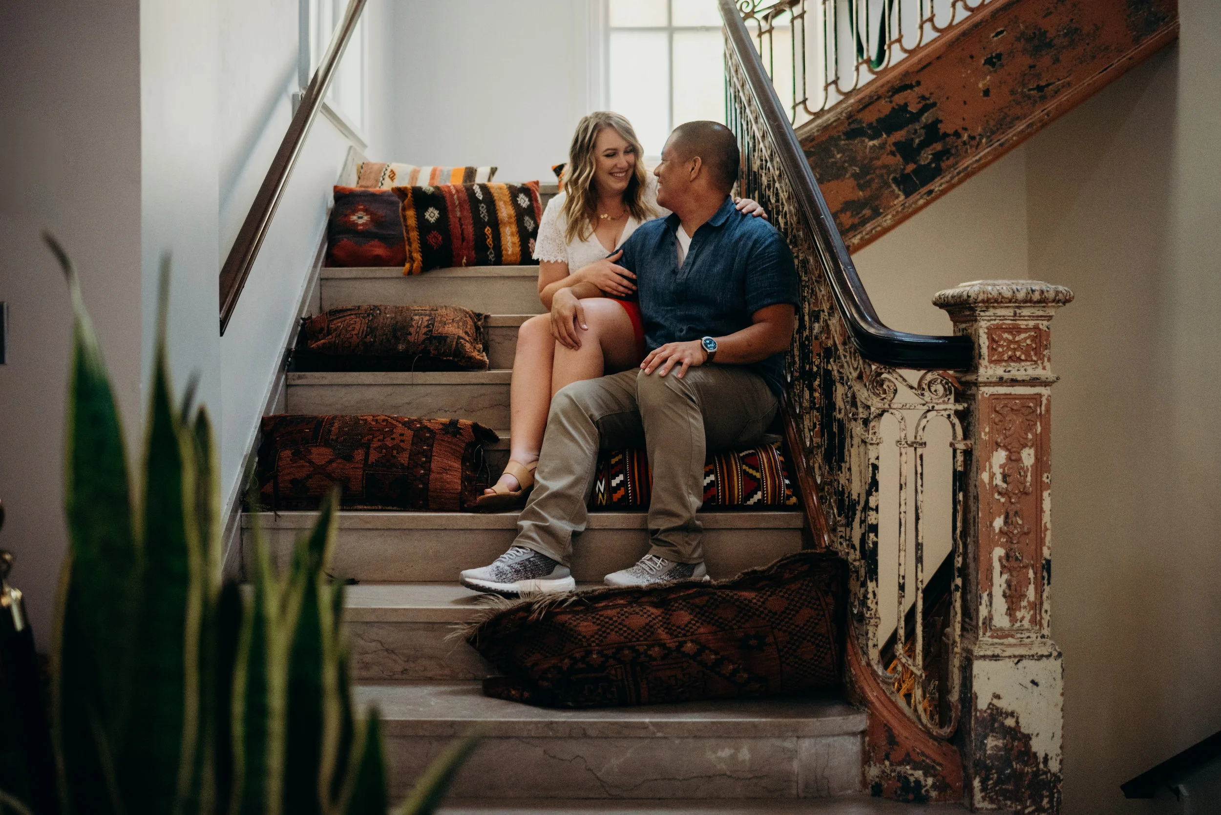 engaged couple sitting on stairs in LINE hotel lobby in Washington DC