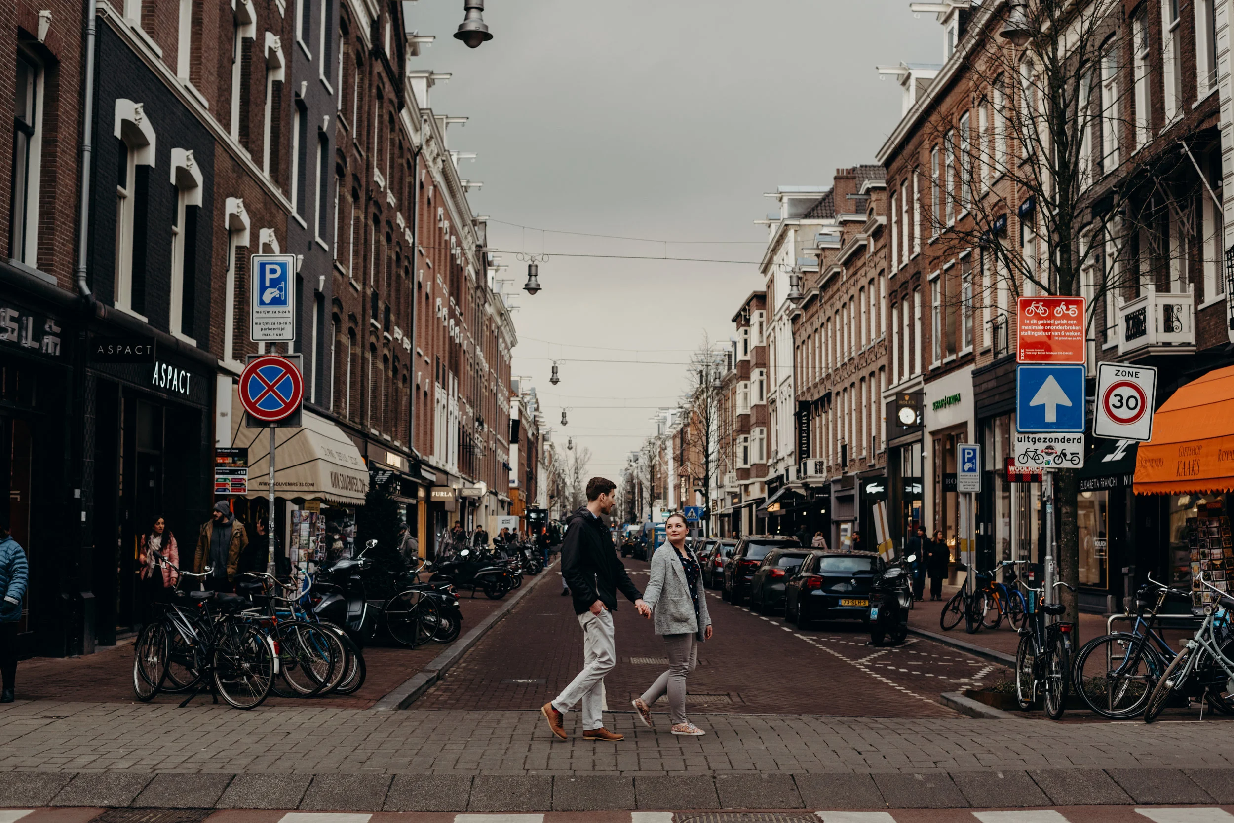 newly married couple walking down streets of Amsterdam