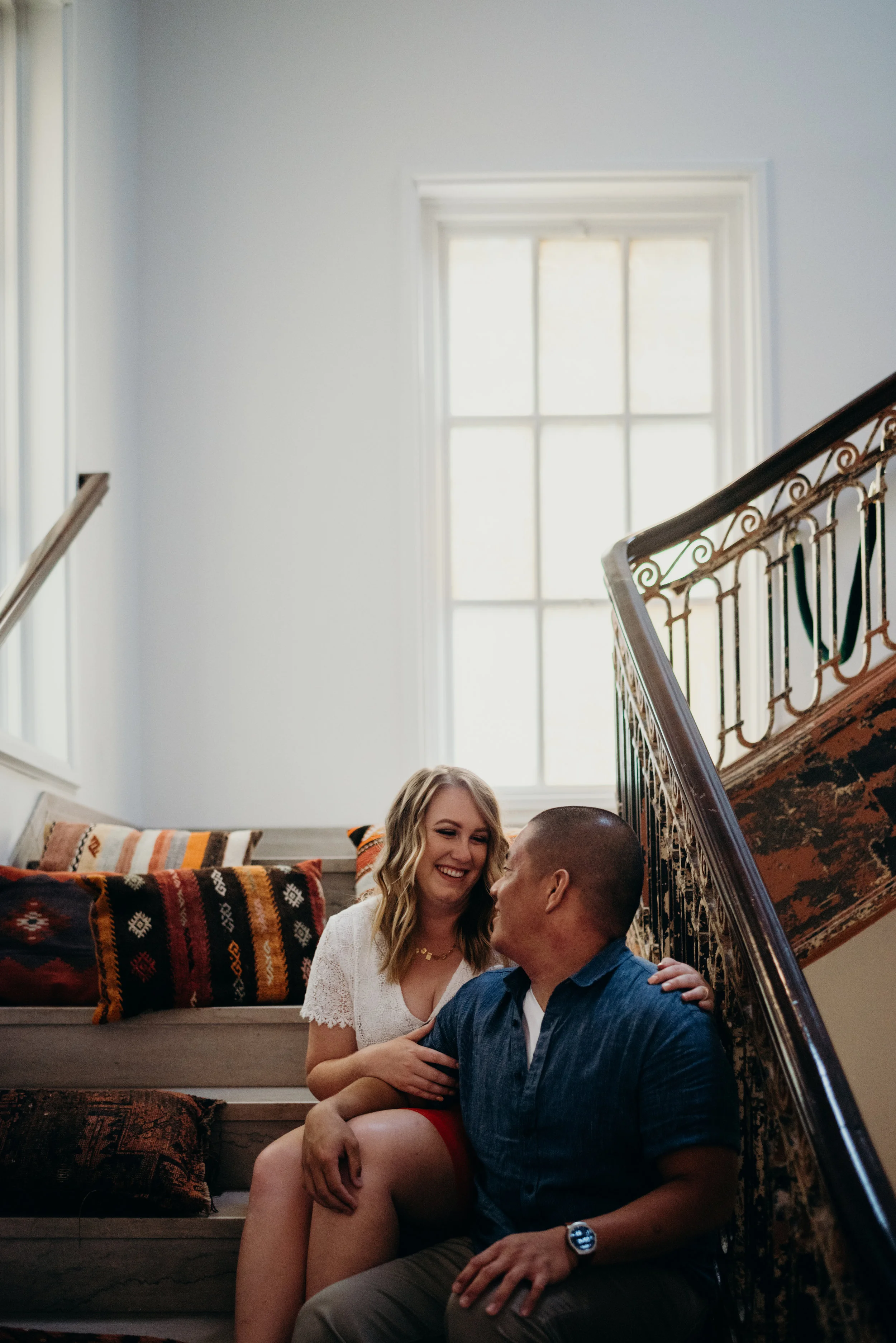 engaged couple sitting on staircase in the lobby of the LINE hotel in Washington DC