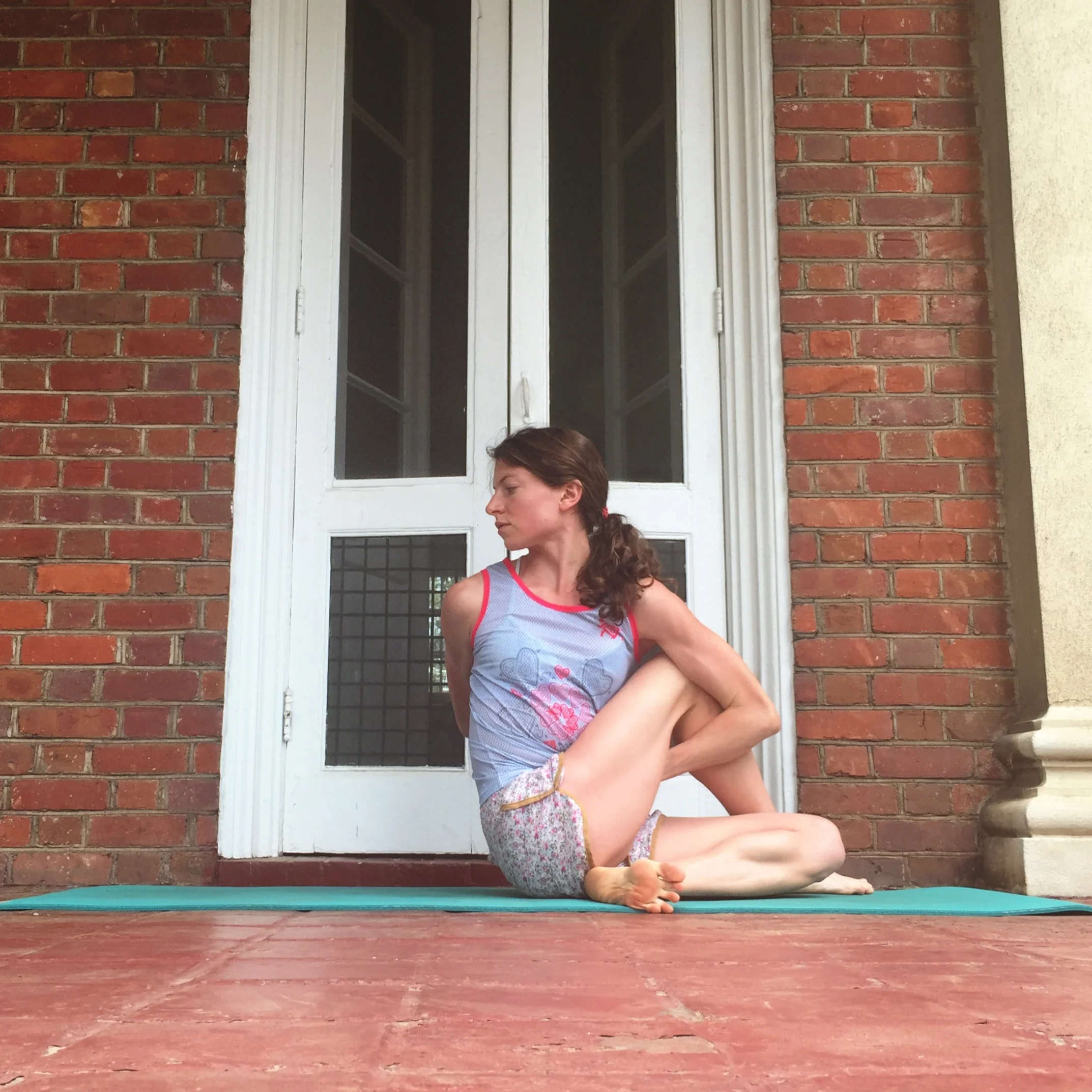   6. HALF LORD OF THE FISHES POSE.    From pigeon, roll to your outer hip. Use your closer hand to gather up back leg--cross foot of this leg over your front knee. Be sure both hips are planted down. Twist towards the side of your top leg. Bind or ju