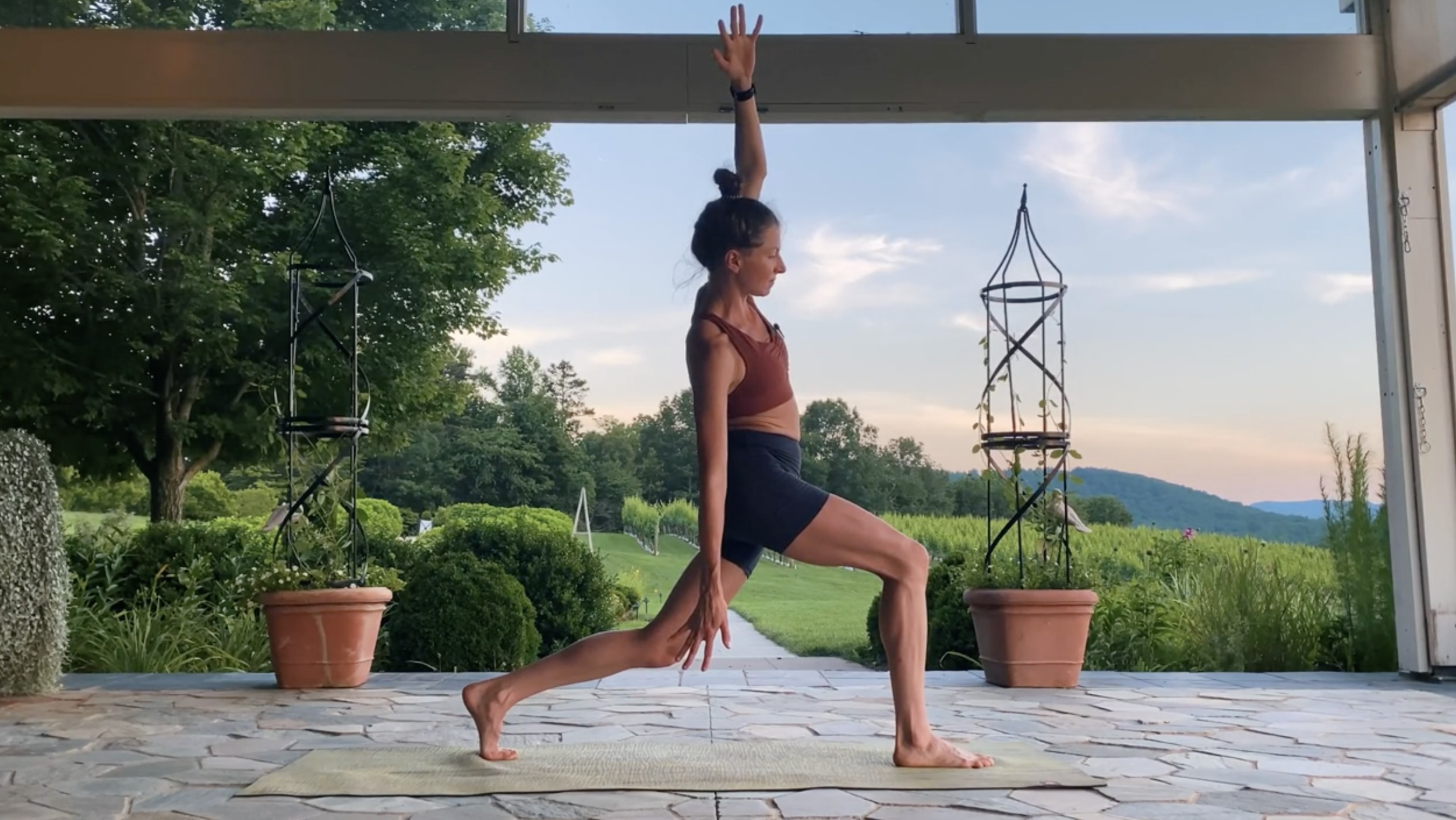 Mid-flow with high lunge: this movement involves dropping the back knee slightly to get a quad stretch while reaching the arm on the same side up and over to get into that side of the hip.