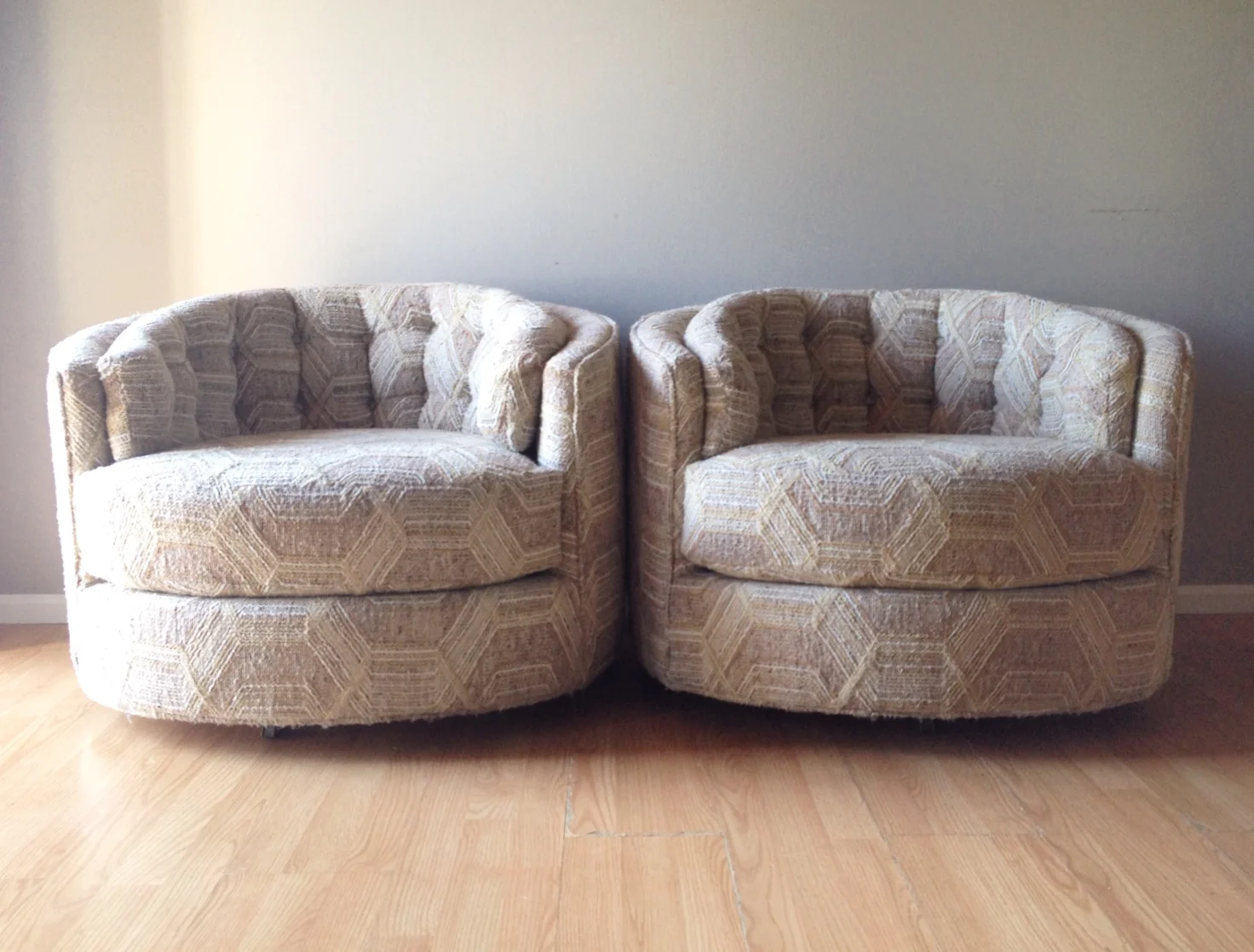 pair of vintage Milo Baughman style round swivel chairs.