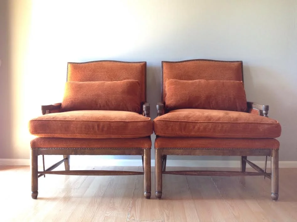 pair of vintage chairs with nailhead trim.