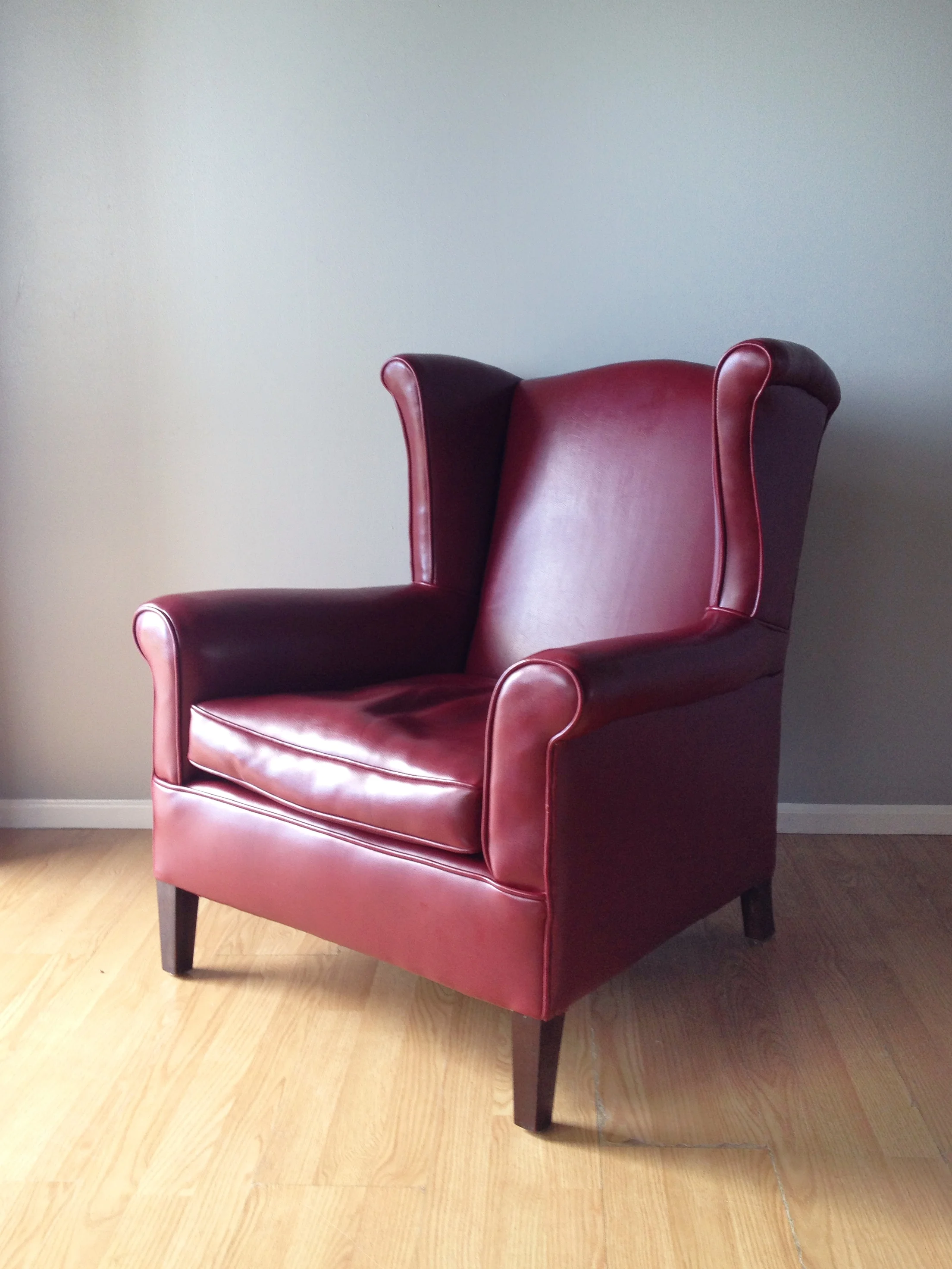 vintage 1960s Naugahyde wingback chair.