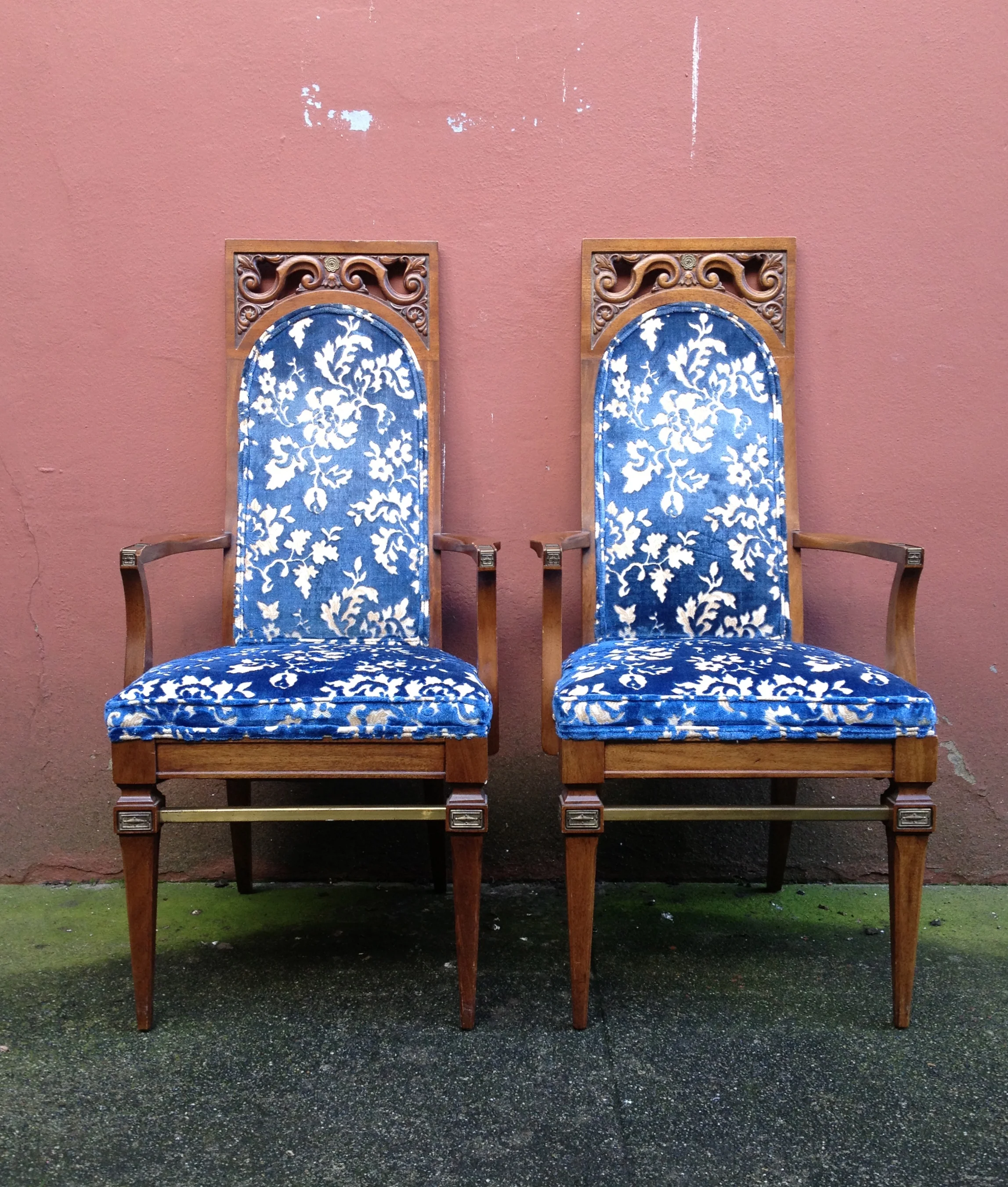 pair of vintage chairs with carved details.