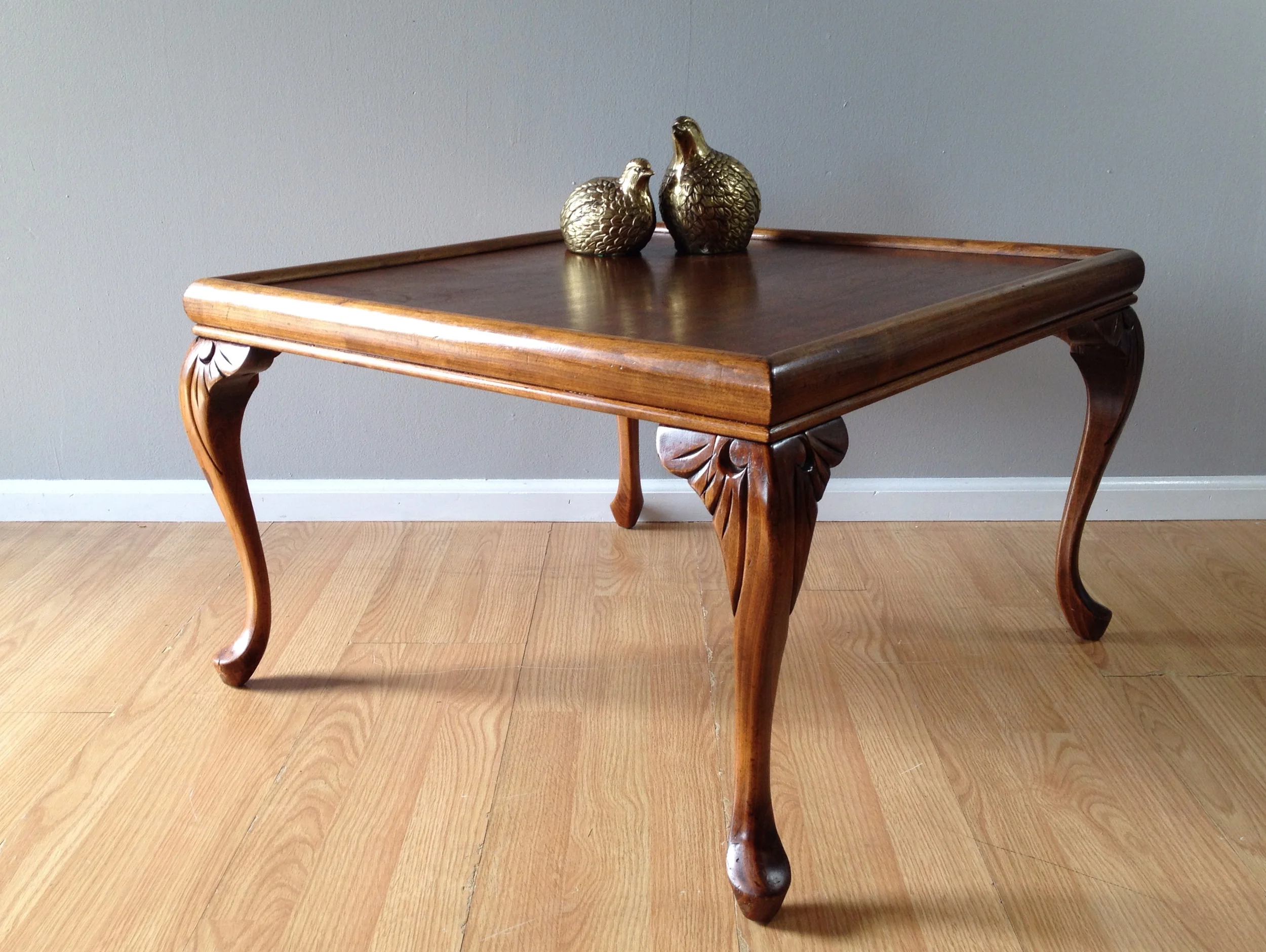 vintage square occasional table with carved cabriole legs.