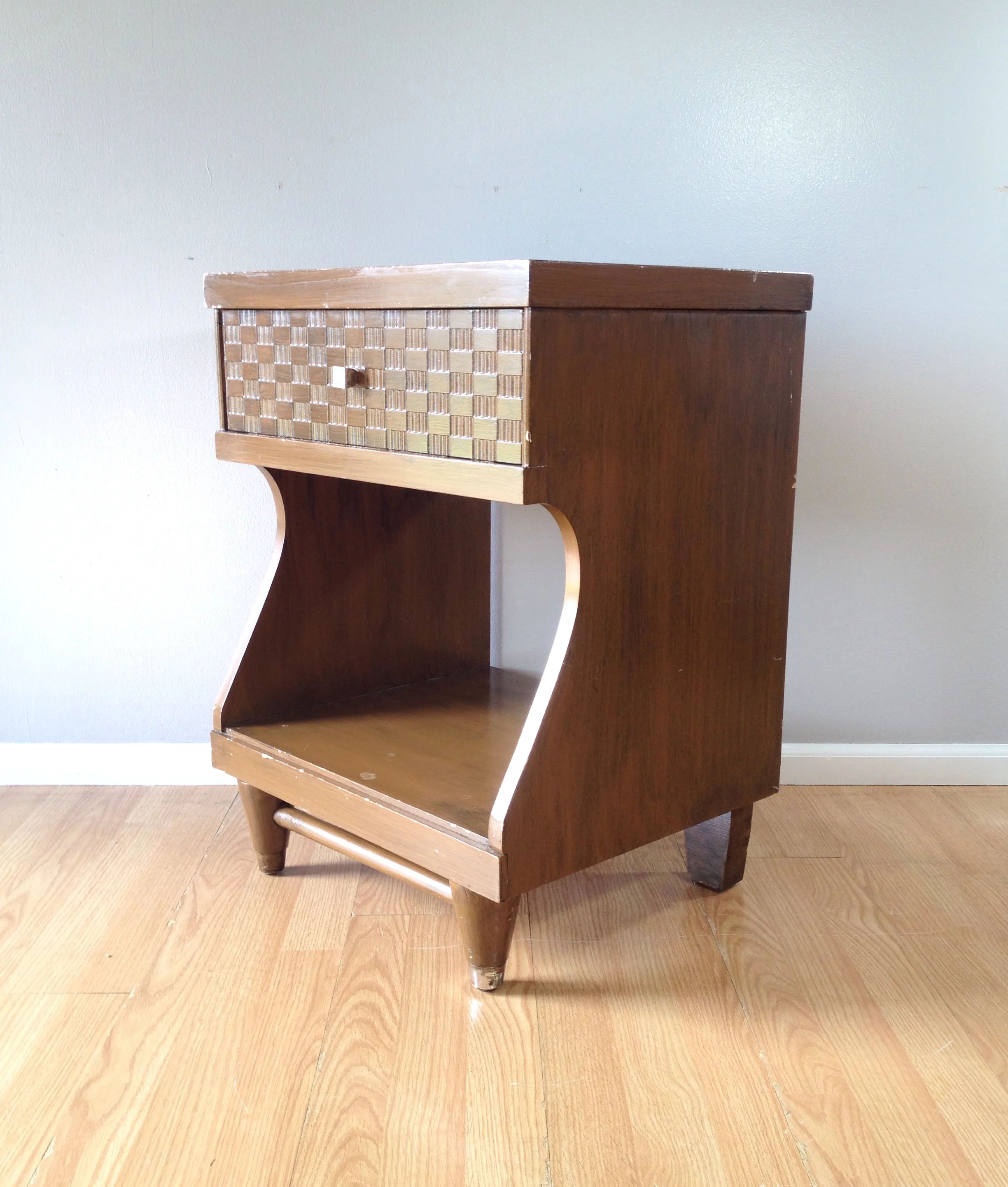 vintage nightstand with faux basket weave accent.