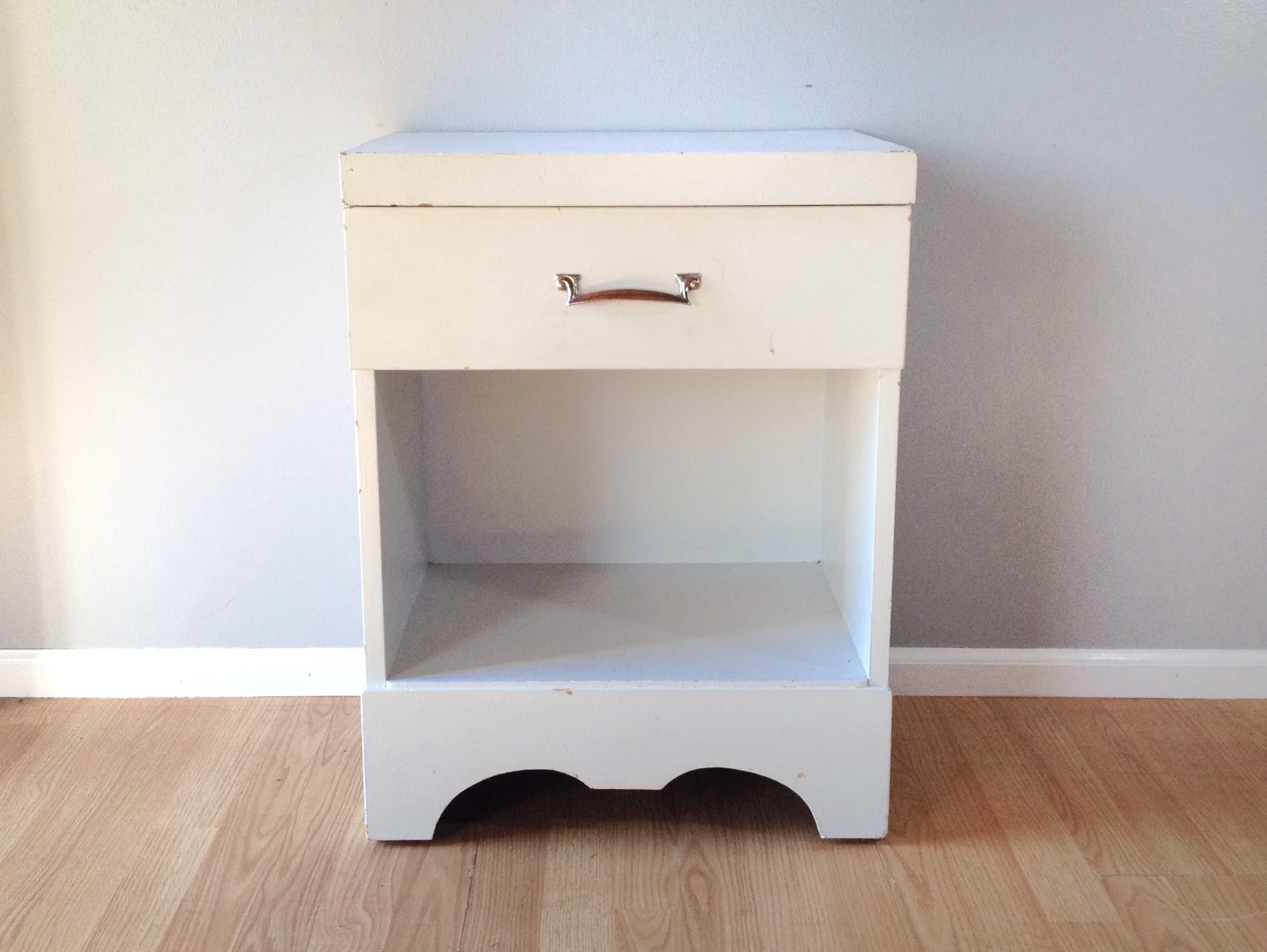 vintage nightstand in distressed white paint.