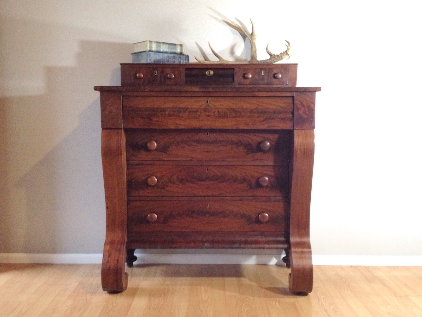 antique 1800's empire dresser in flaming mahogany.