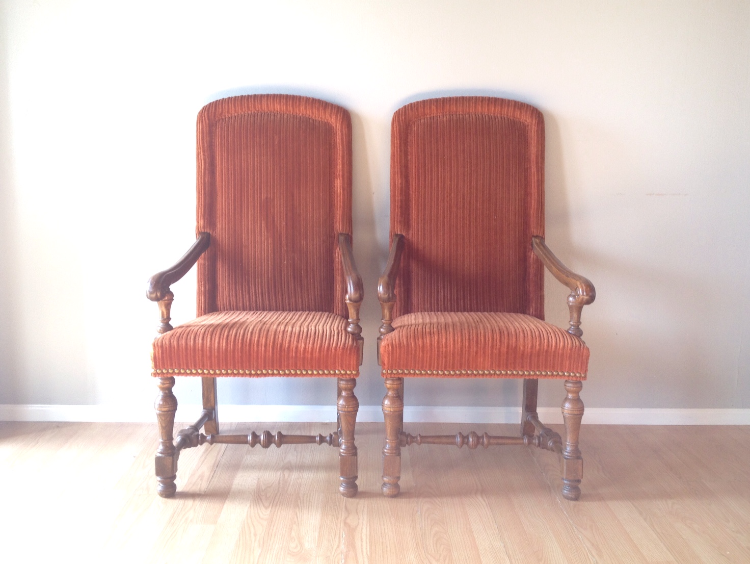 pair of vintage orange throne chairs.